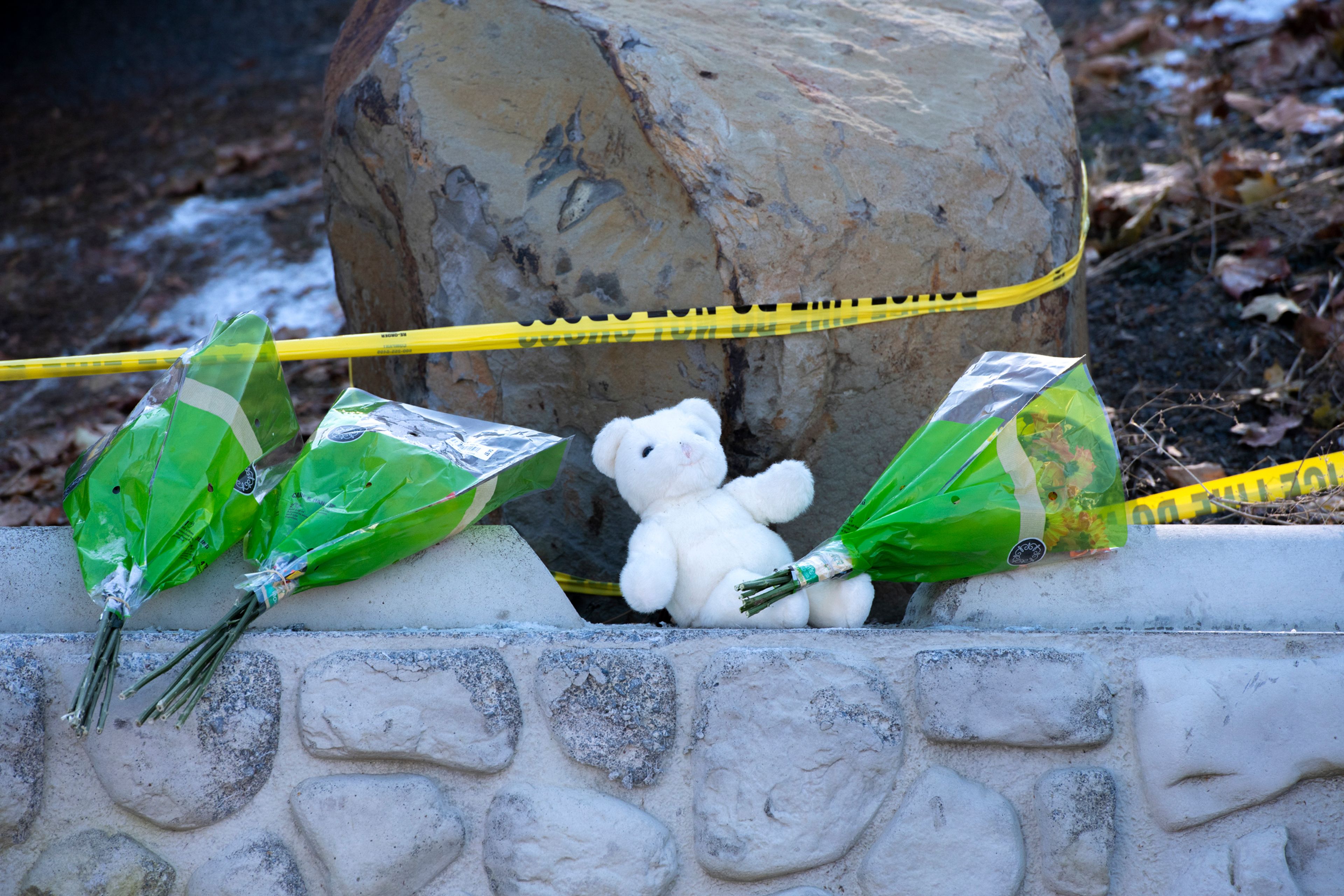 Three bouquets of flowers and a white teddy bear were placed on the perimeter of the crime scene Thursday where four University of Idaho students were murdered in an off-campus house in Moscow.