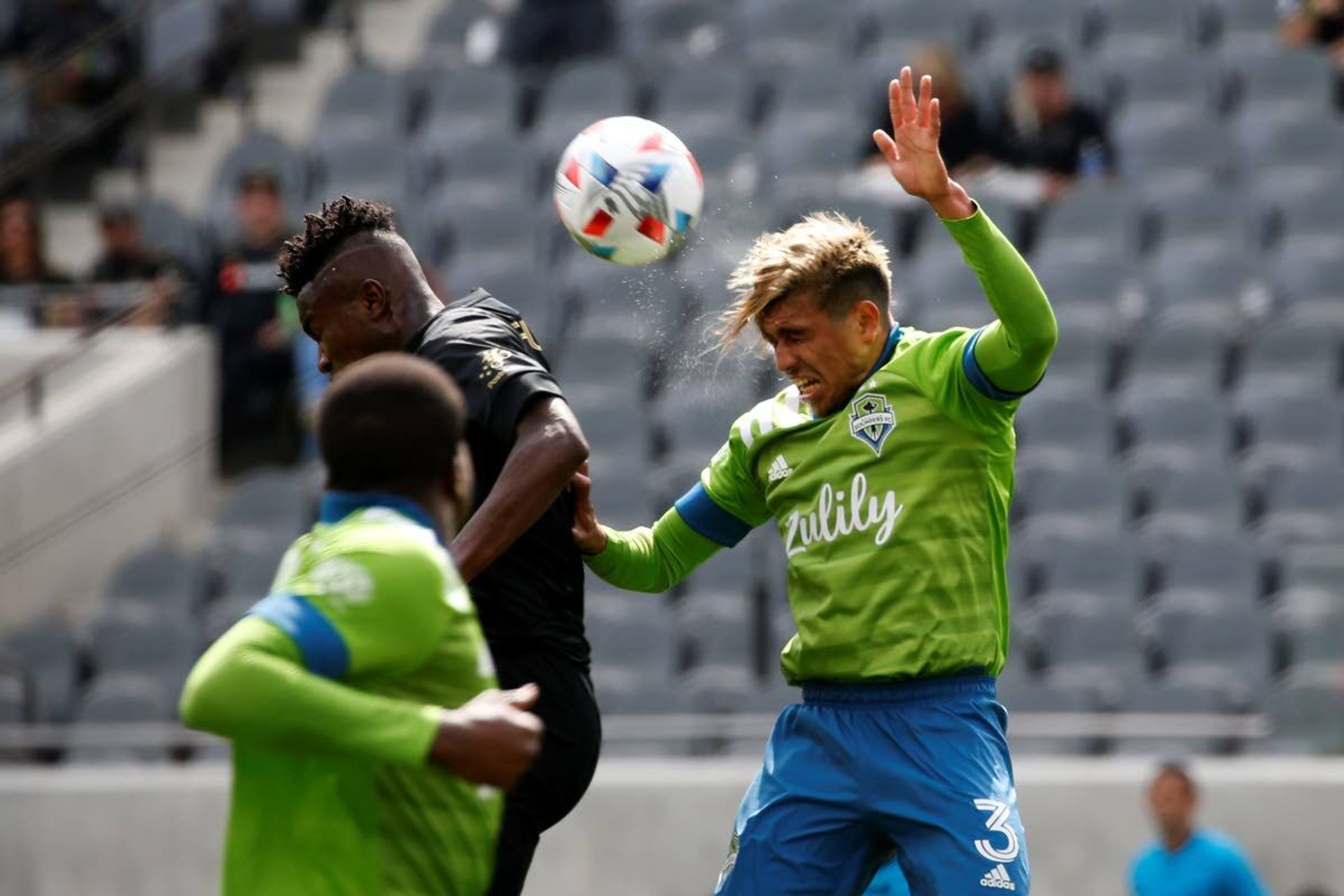 Seattle Sounders defender Xavier Arreage, right, and Los Angeles FC midfielder Jose Cifuentes (11) vie for the head ball during the first half of an MLS soccer match, Saturday, April 24, 2021, in Los Angeles. (AP Photo/Ringo H.W. Chiu)