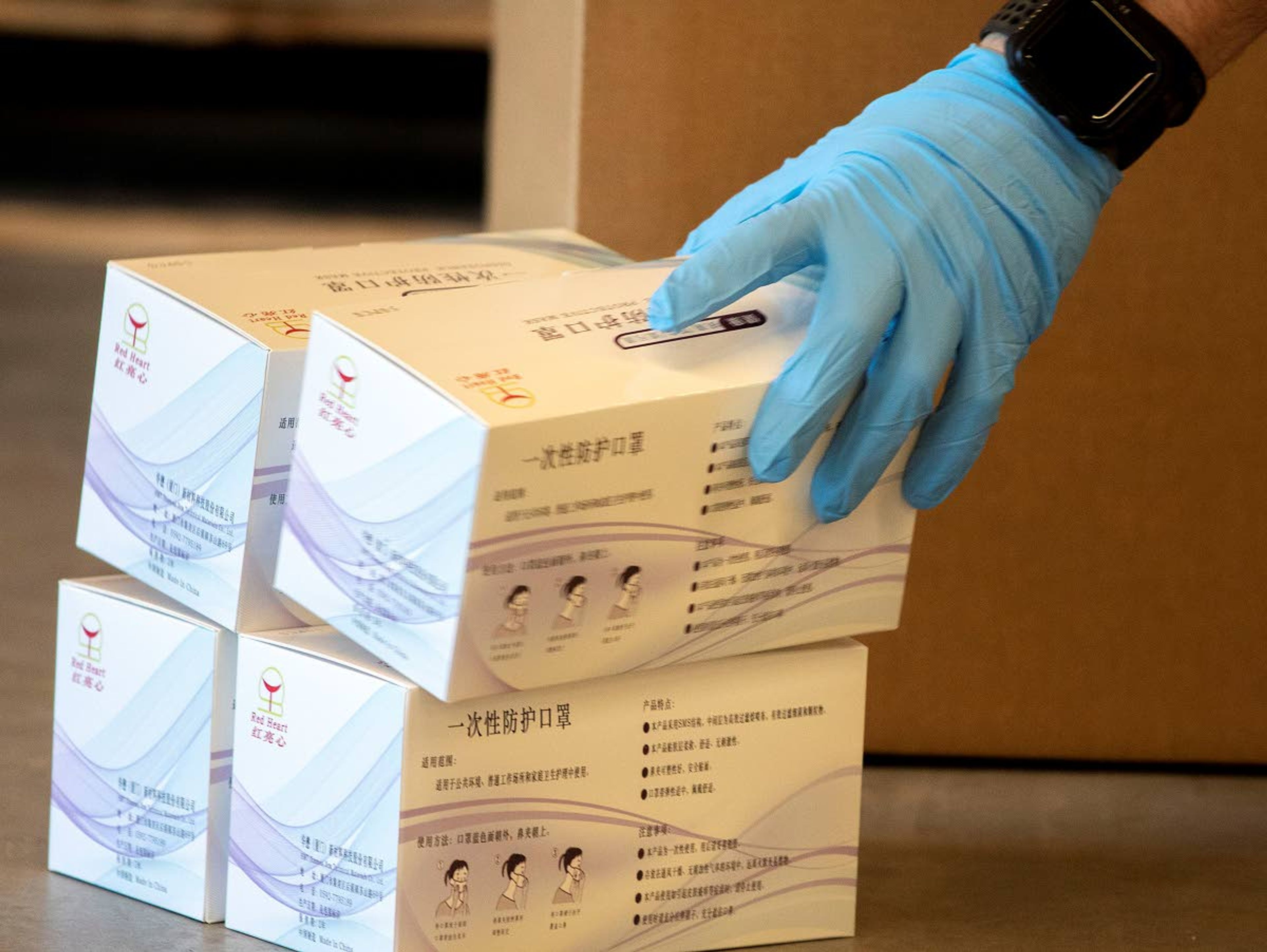 Garrett Payne packs some of the 40,000 disposable protective masks received in shipment of personal protective equipment on Thursday at Northwest River Supplies in Moscow.