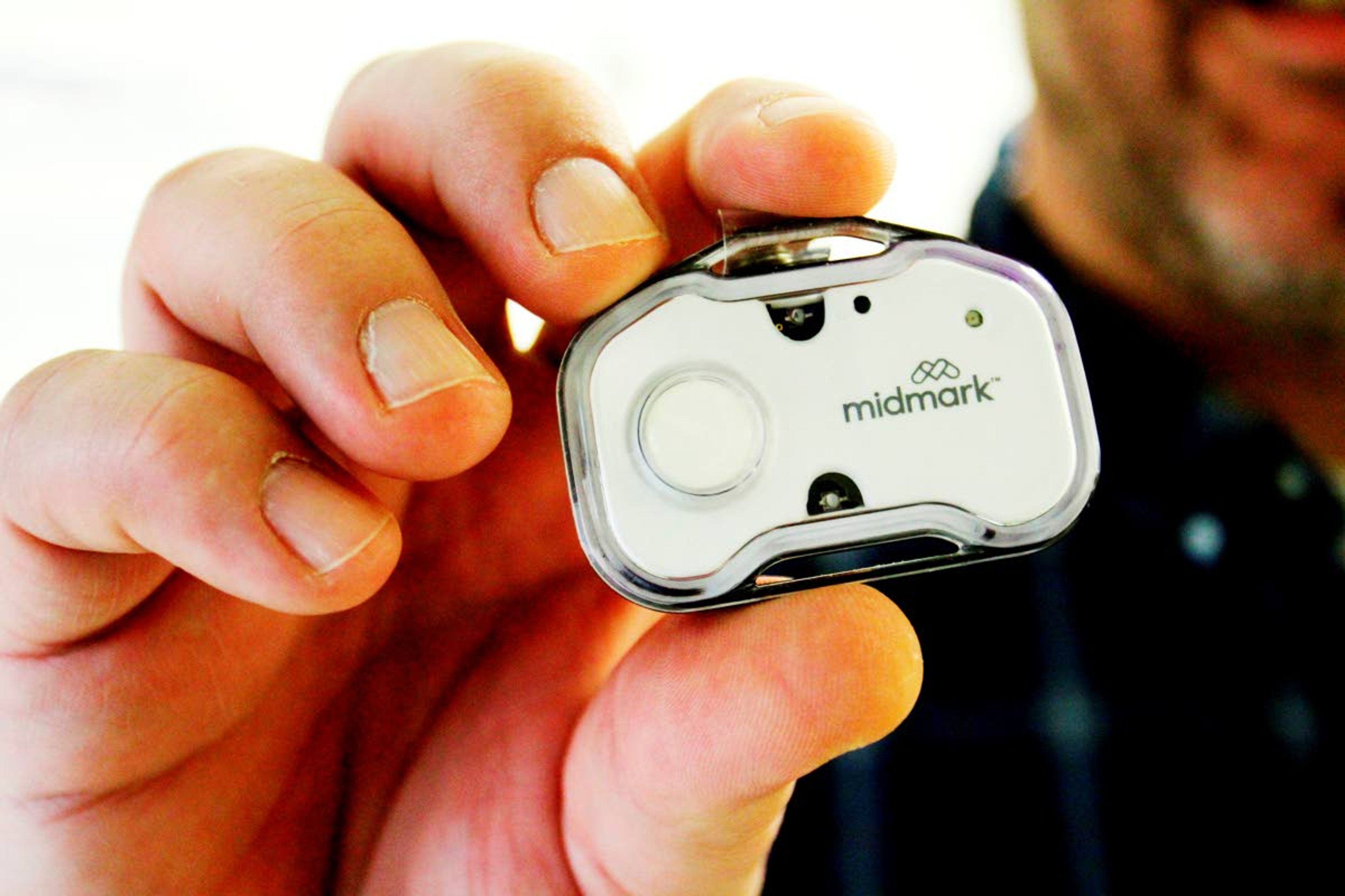 Keith Mathis holds a panic button he helped create as part of CoxHealth's Innovation Accelerators program. Nurses and hundreds of other staff members will soon begin wearing panic buttons at a Missouri hospital where assaults on workers tripled after the onset of the COVID-19 pandemic. (Sara Karnes/The Springfield News-Leader via AP)