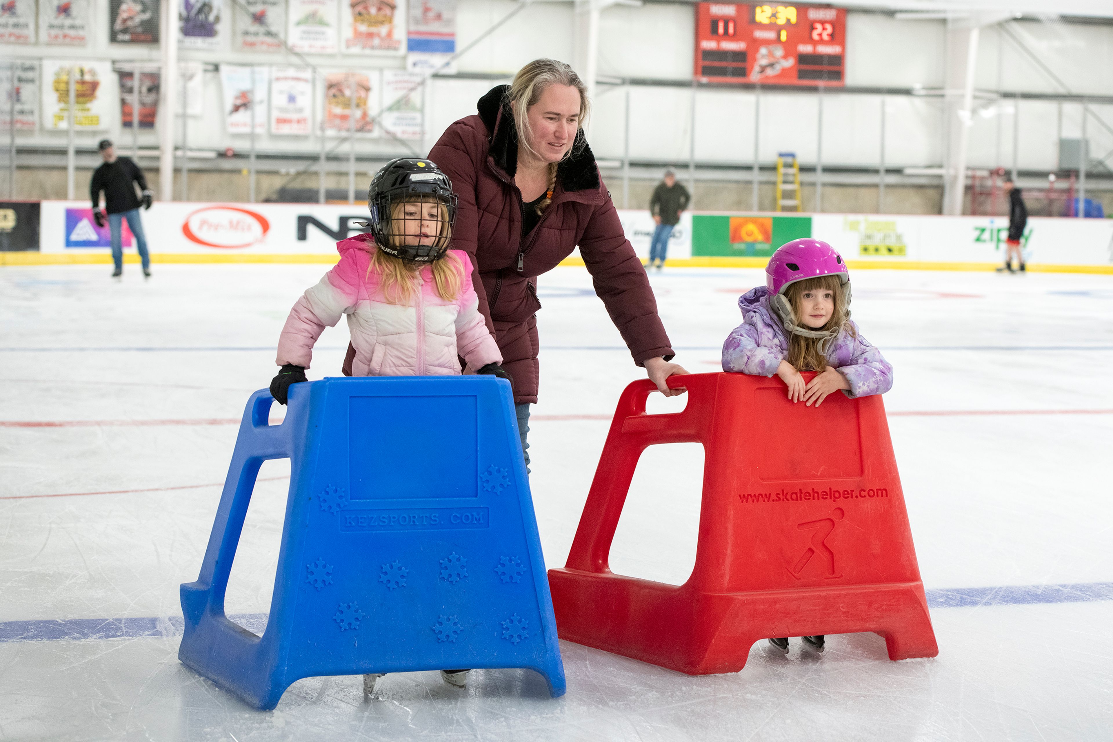 Angela Norton assists her daughters Ainsley, 5, and Tegan, 4, as they skate during the opening night of the new Palouse Ice Rink in Moscow on Monday.