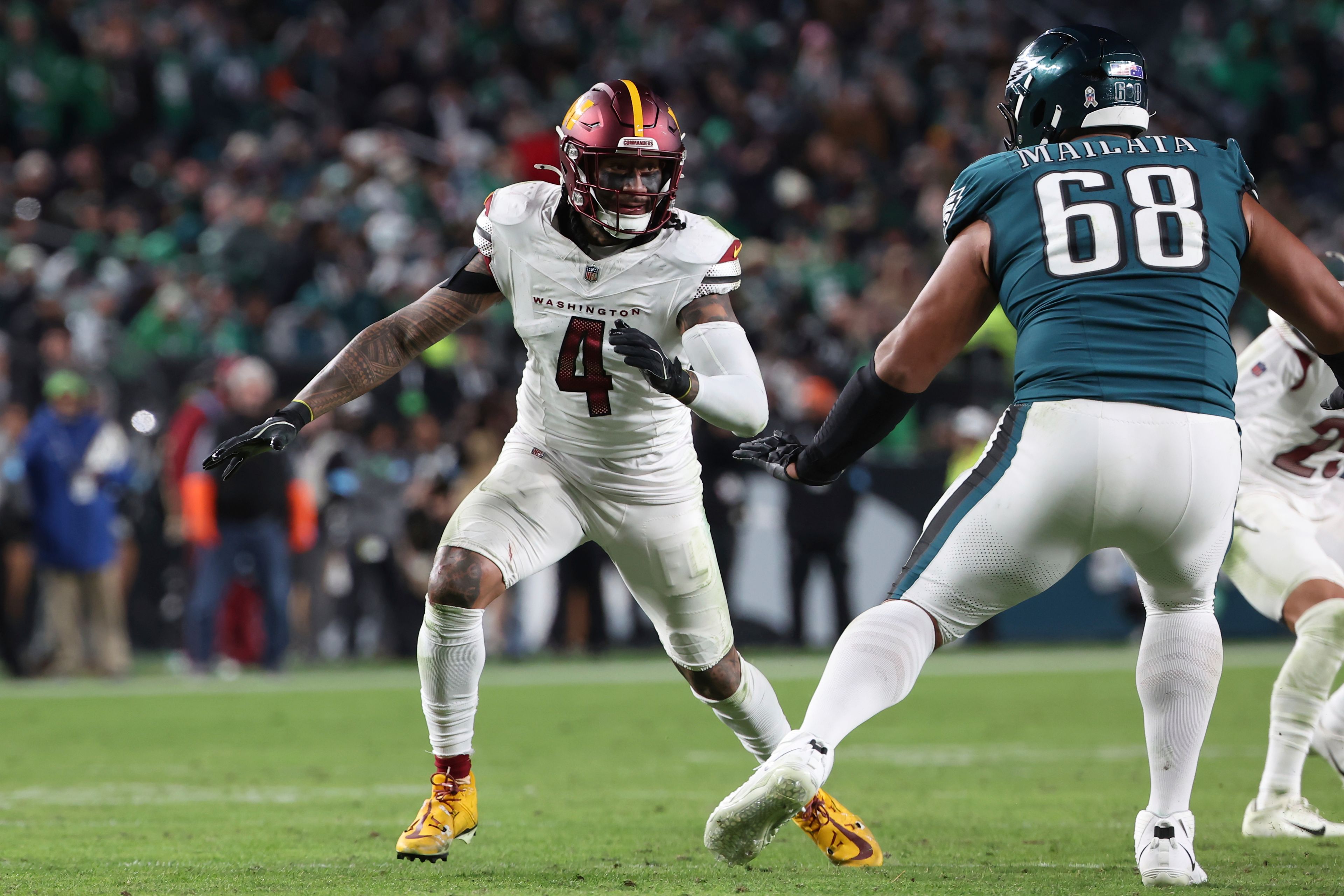 Washington Commanders linebacker Frankie Luvu (4) rushes the passer during an NFL football game against the Philadelphia Eagles, Thursday, Nov. 14, 2024, in Philadelphia, PA. (AP Photo/Peter Joneleit)