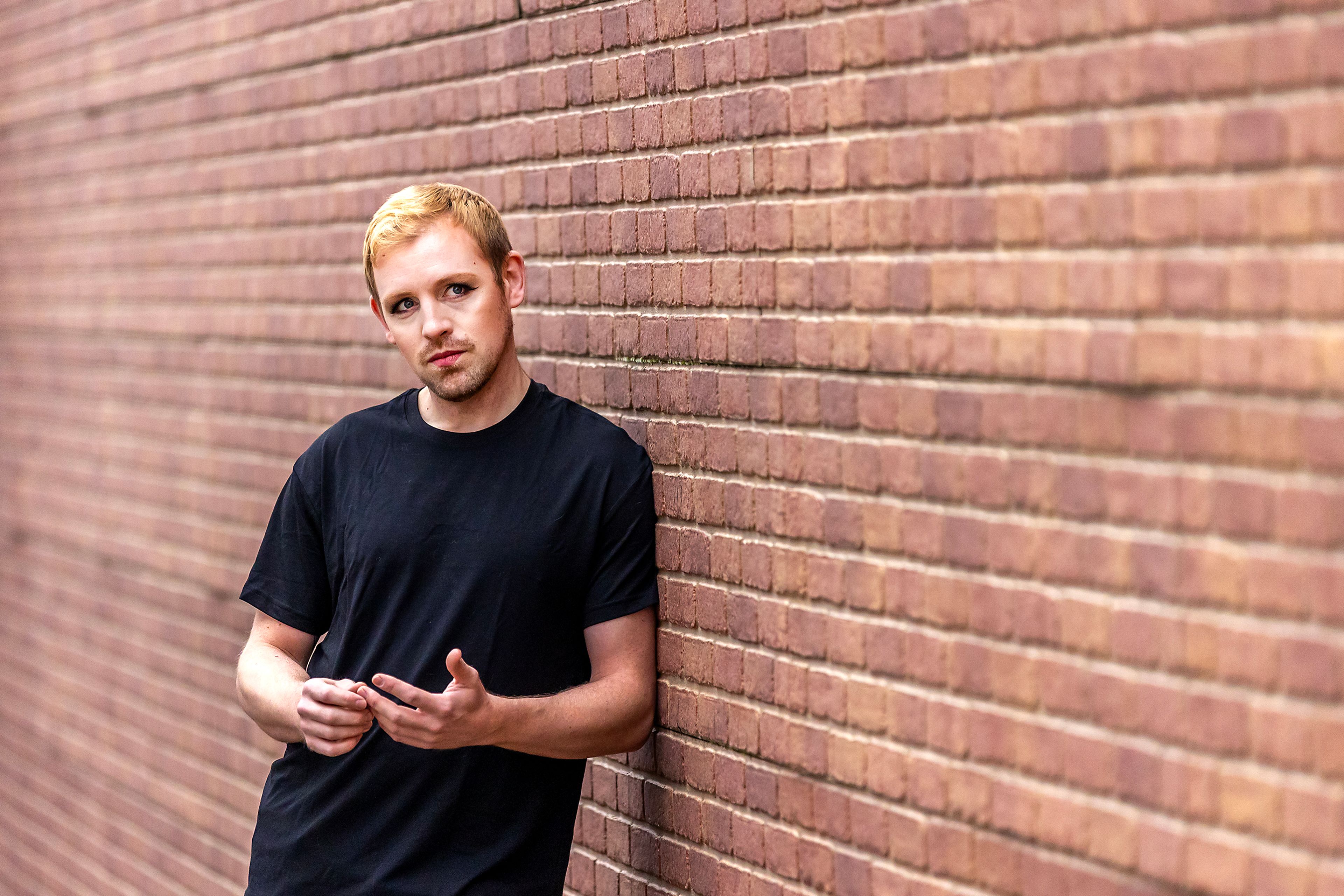 Micheal Keene poses for a photo wearing 2010s-inspired makeup applied by Jacey Johnson.