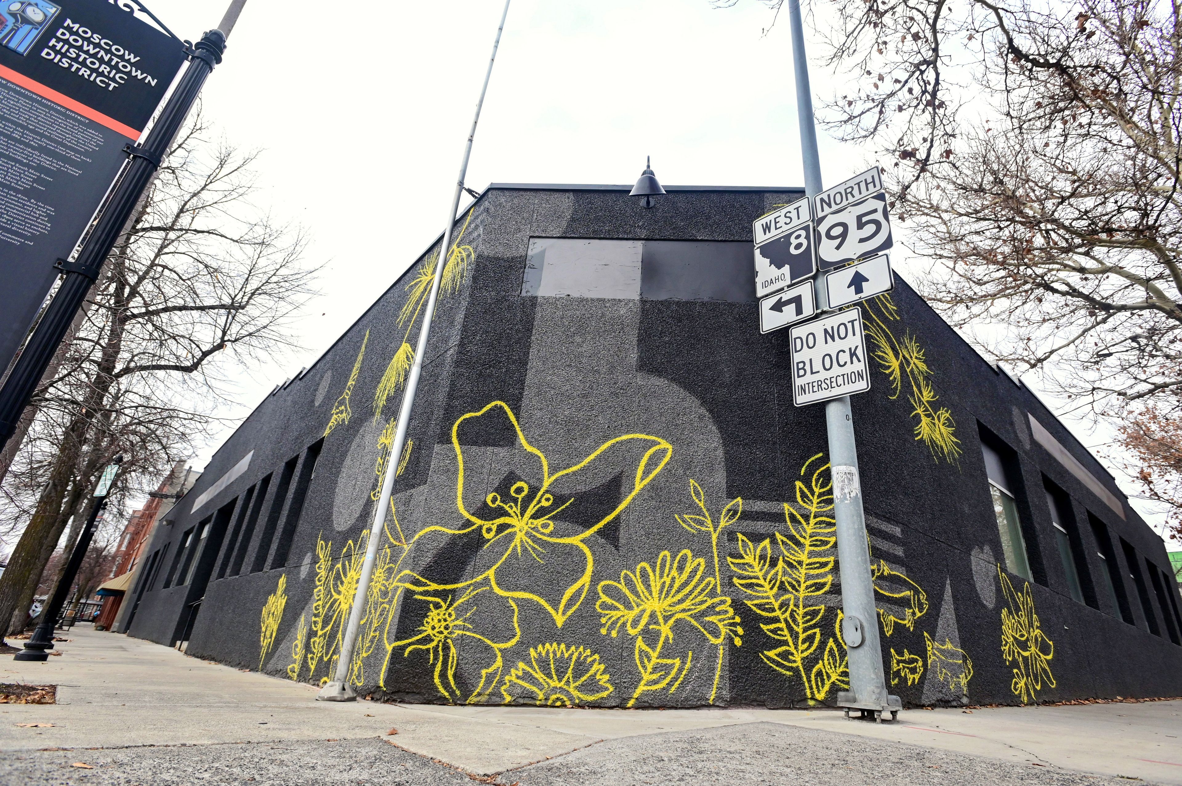 A mural by Mikaela Herrick, a University of Idaho senior studio art and design student, covers the corner of a building at the intersection of Fourth and Washington streets in Moscow on Thursday.