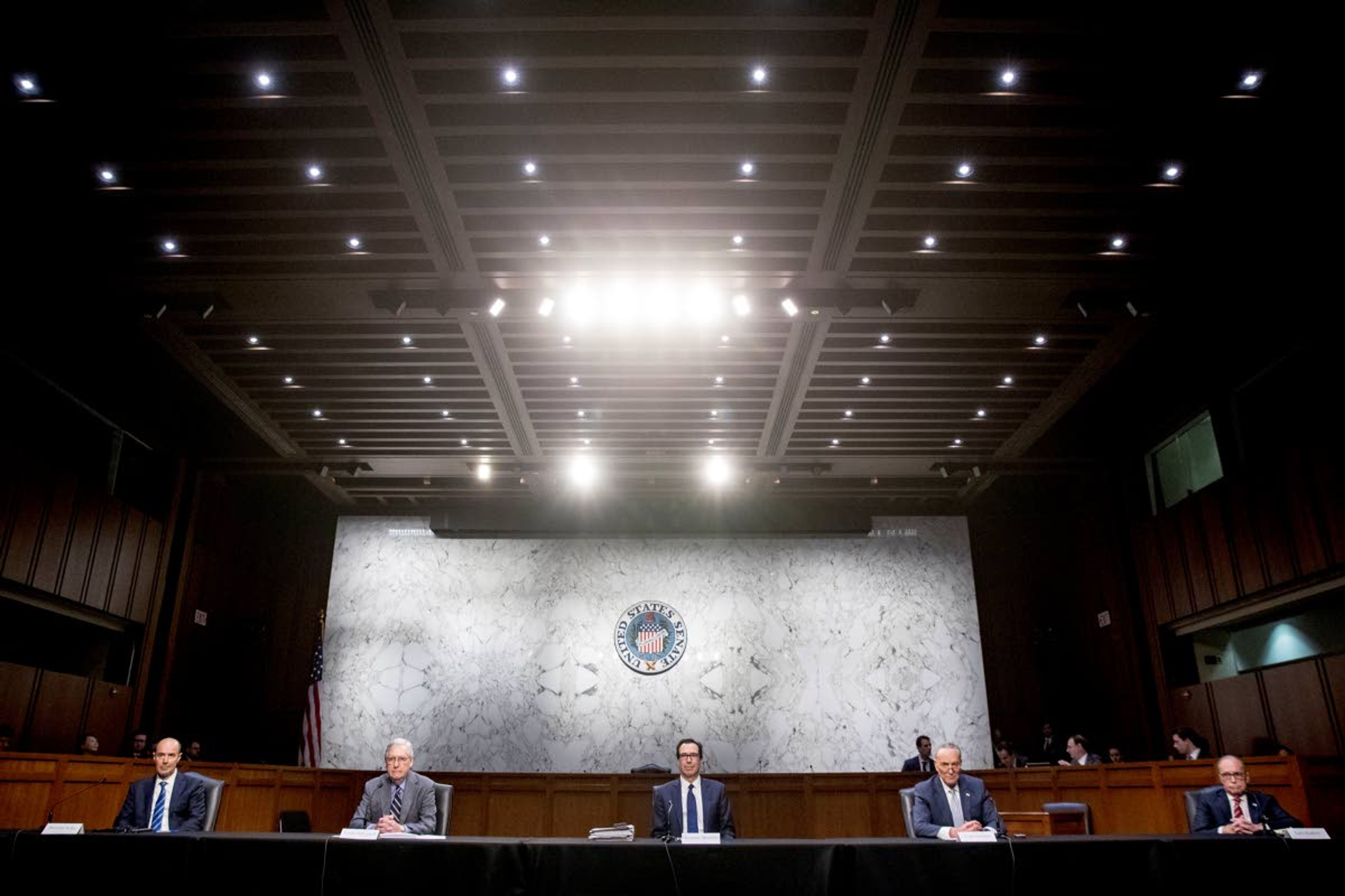 FILE - In this March 20, 2020, file photo from left, Labor Secretary Eugene Scalia, Senate Majority Leader Mitch McConnell of Ky., Treasury Secretary Steven Mnuchin, Senate Minority Leader Sen. Chuck Schumer of N.Y., and White House chief economic adviser Larry Kudlow attend a a meeting to discuss the coronavirus relief bill on Capitol Hill Washington. (AP Photo/Andrew Harnik, File)