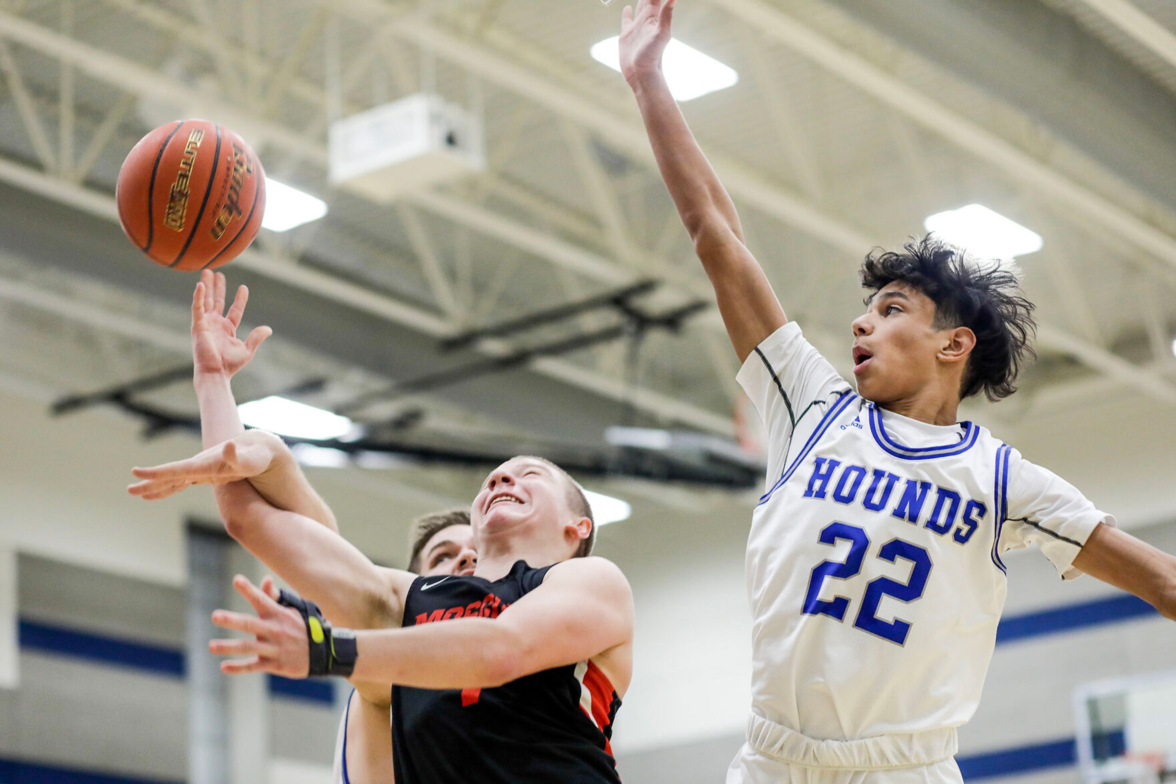 Moscow guard Cody Wilson, left, shoots the ball as Pullman guard Caleb Northcroft defends during Saturday's nonleague boys basketball game.