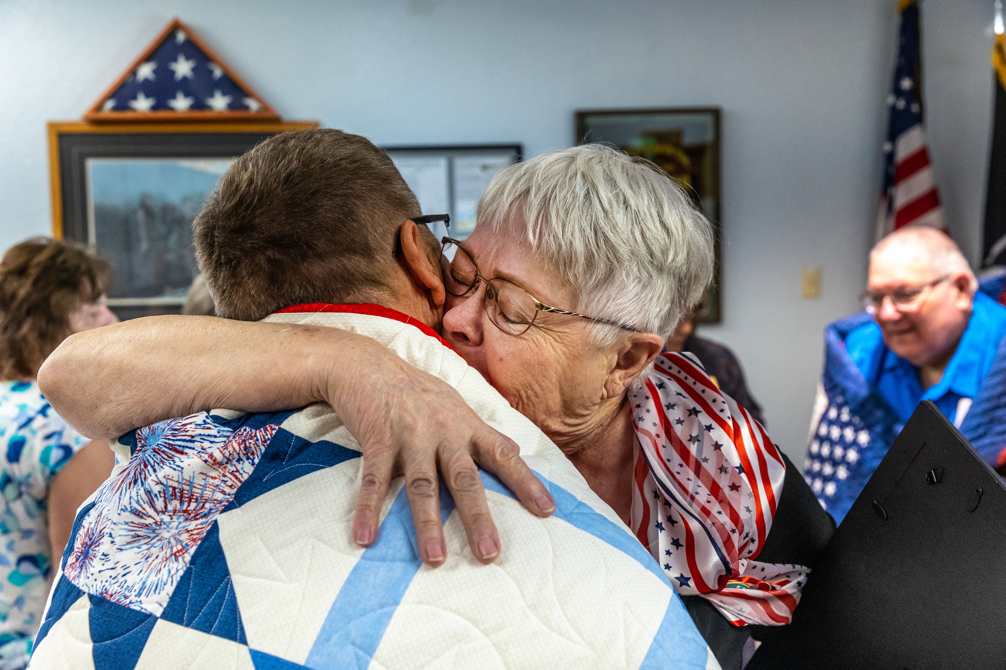 Sharon Ledbetter embraces Mark Janowski after Janowski received a quilt of valor and Ledbetter received a congressional letter from Washington Representative Cathy McMorris Rodgers for starting Quilts of Valor in the Lewiston-Clarkston Valley, Friday at the Clarkston VFW.