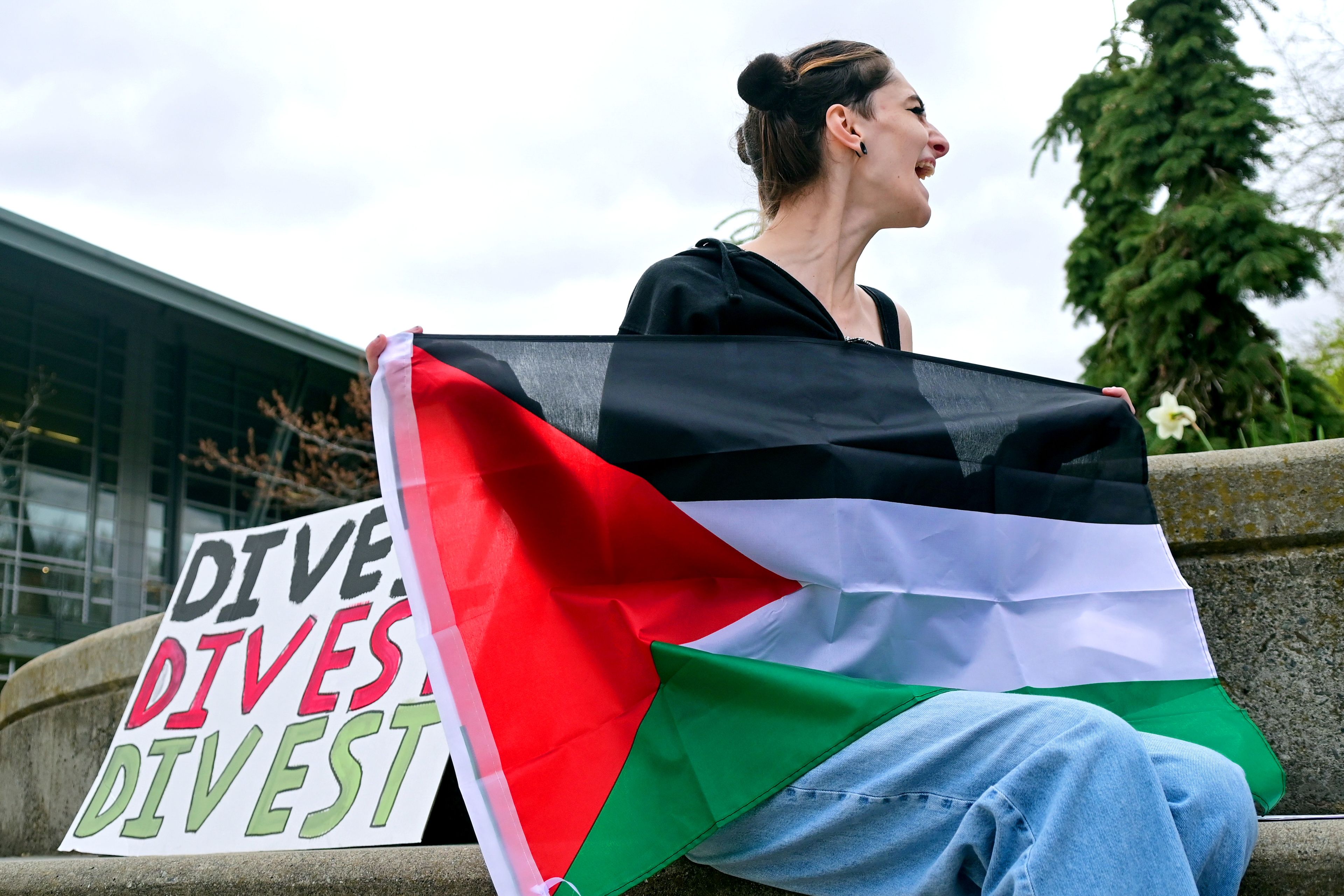 Kai Ohmes, a senior University of Idaho student, cheers in support of a speaker at a pro-Palestine demonstration on Thursday outside of the UI Library in Moscow.