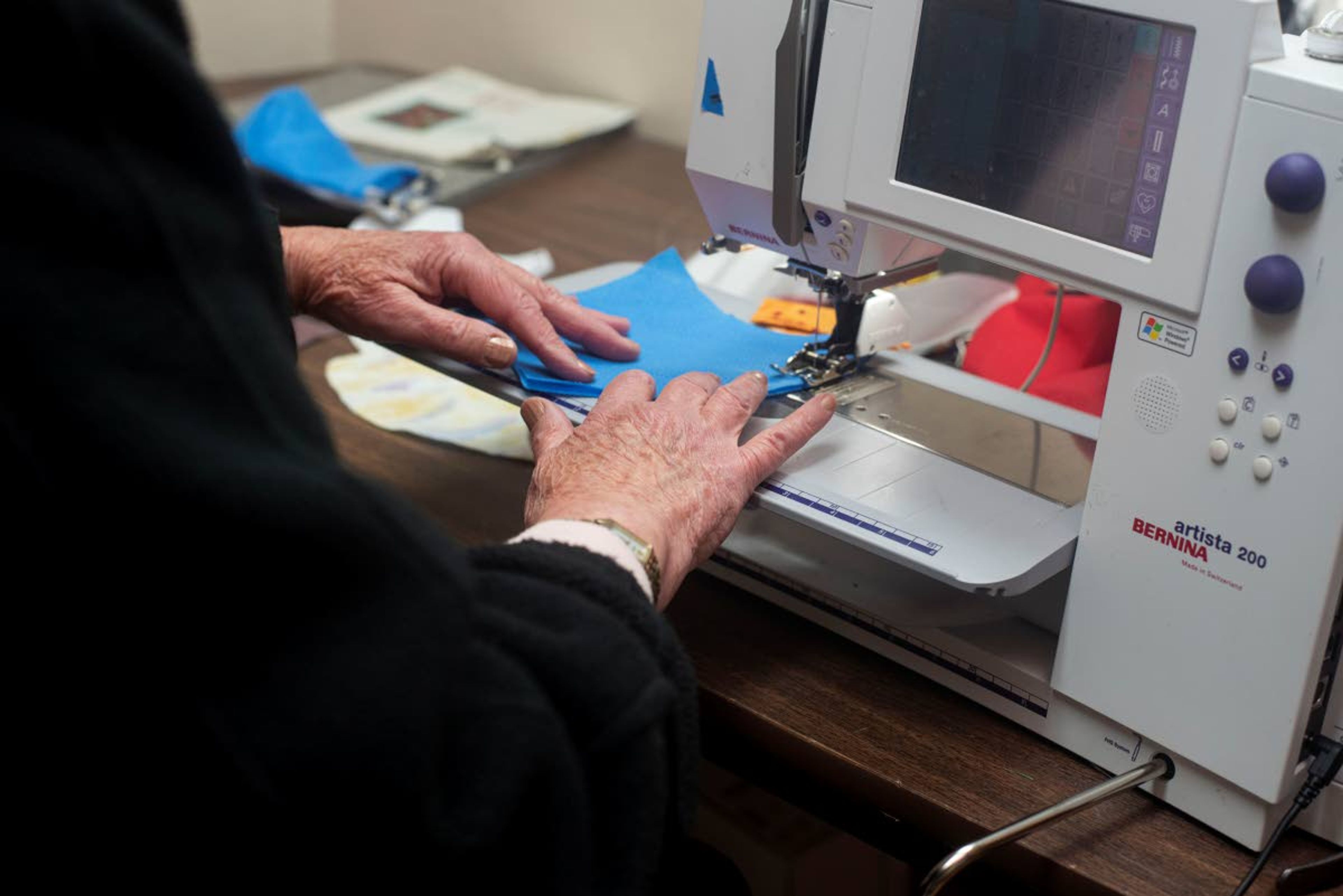 Scott sews fabric for her handmade masks in her Moscow apartment Wednesday morning.