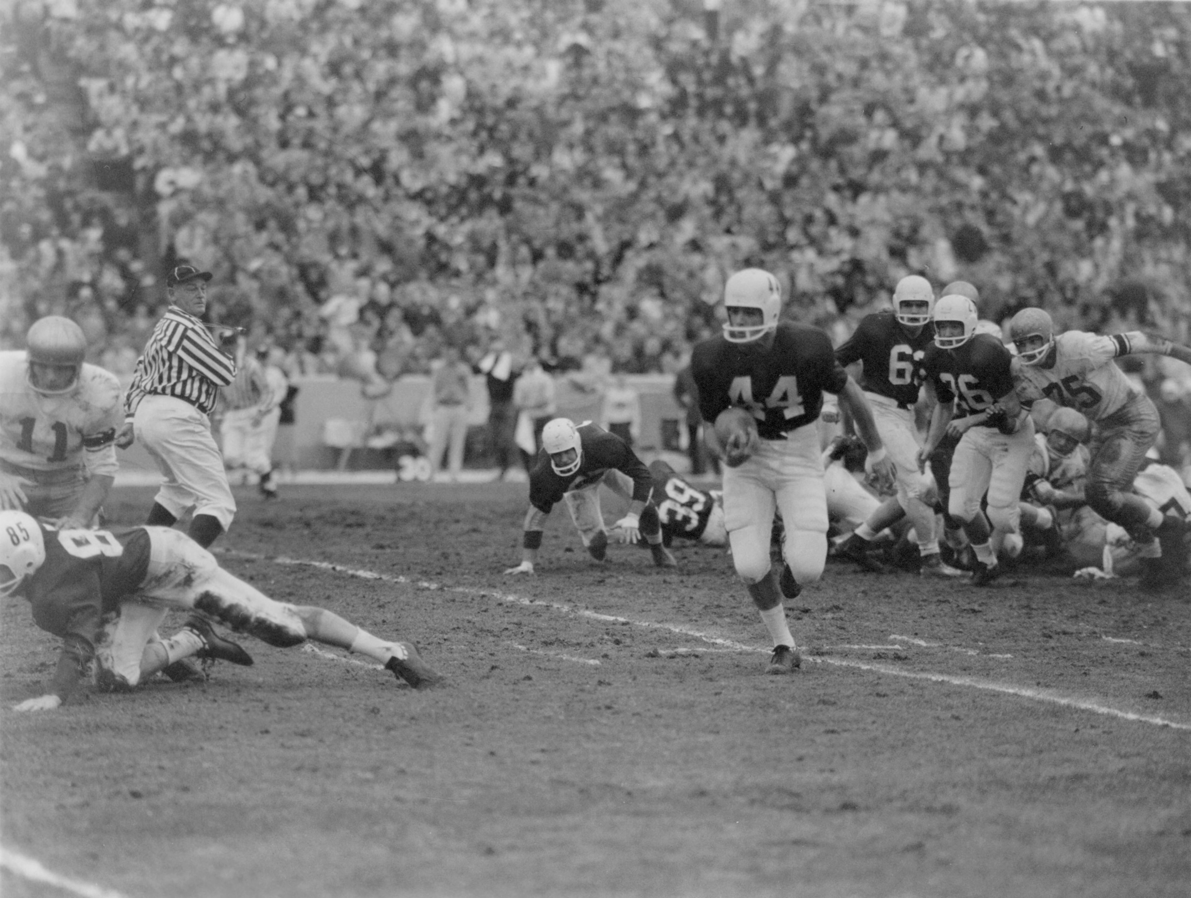 Running back Ted Cano (44) breaks free for a large gain as, in their final Pacific Coast Conference game, Washington State University beats the University of Washington 18-14 in Spokane. Unfortunately, University California edged Stanford University 16-15 in a game ending just minutes later, and Cal took that Rose Bowl spot from WSU.