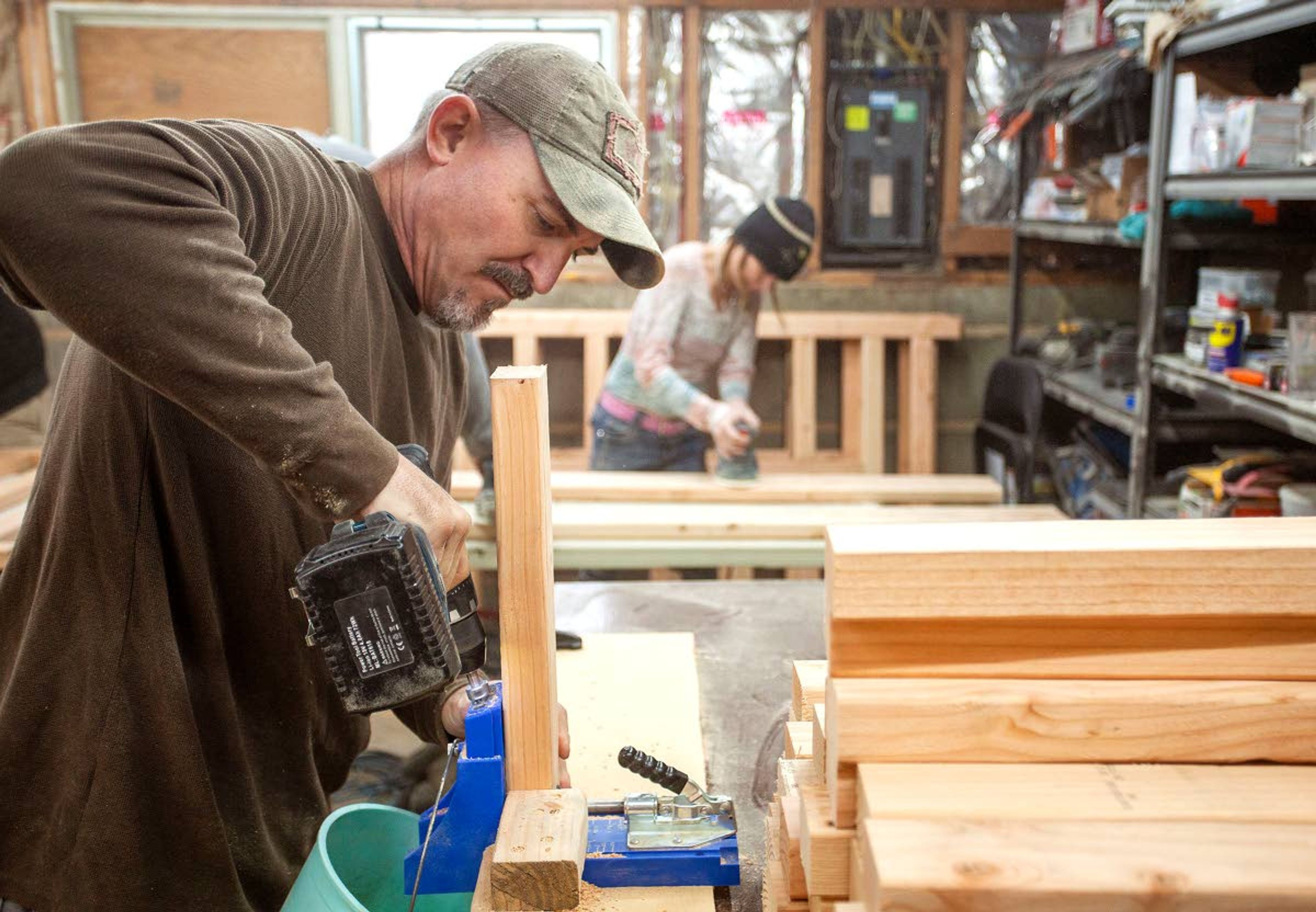 Blessing Beds founder Thad DeBuhr, left, and volunteer Misty Zornacki build beds Feb. 7 at Debuhr’s home in Pullman. The beds will be donated to children who would otherwise sleep on the floor.