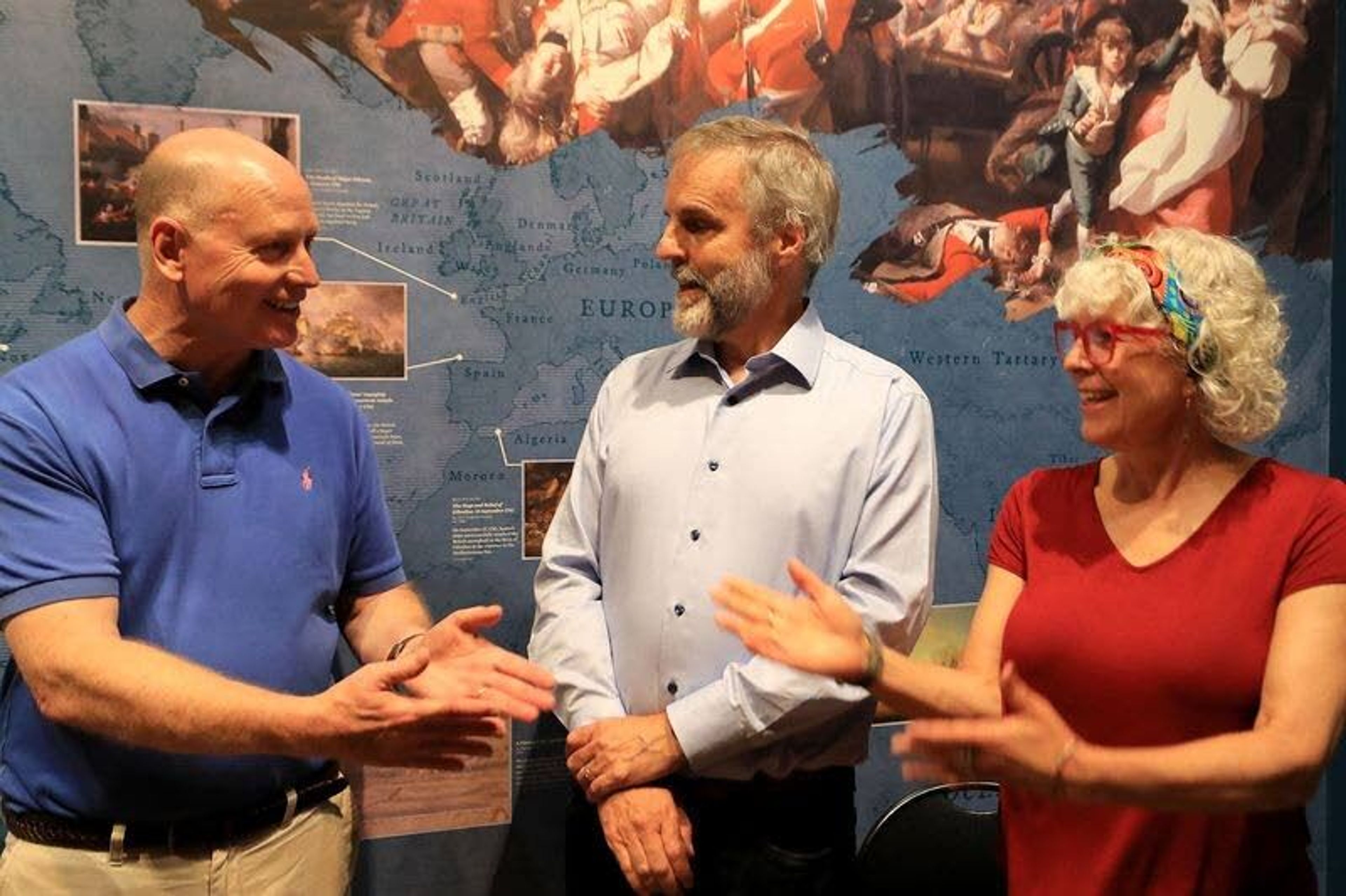 Stephen Balderston, left, talks with David and Aileen Edge.