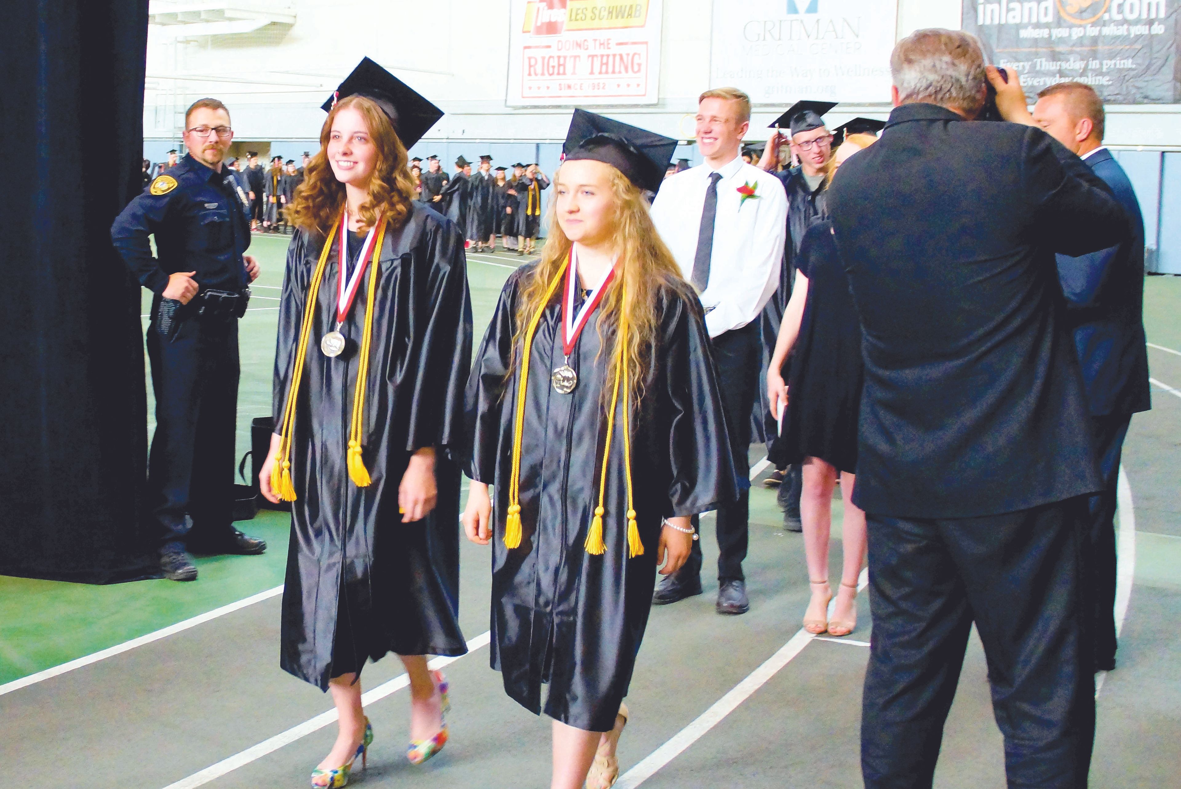 Class presidents Emma Carscallen, left, and Emma Clark lead Moscow High School's class of 2017 in the school's commencement processional Friday evening in the Kibbie Dome.