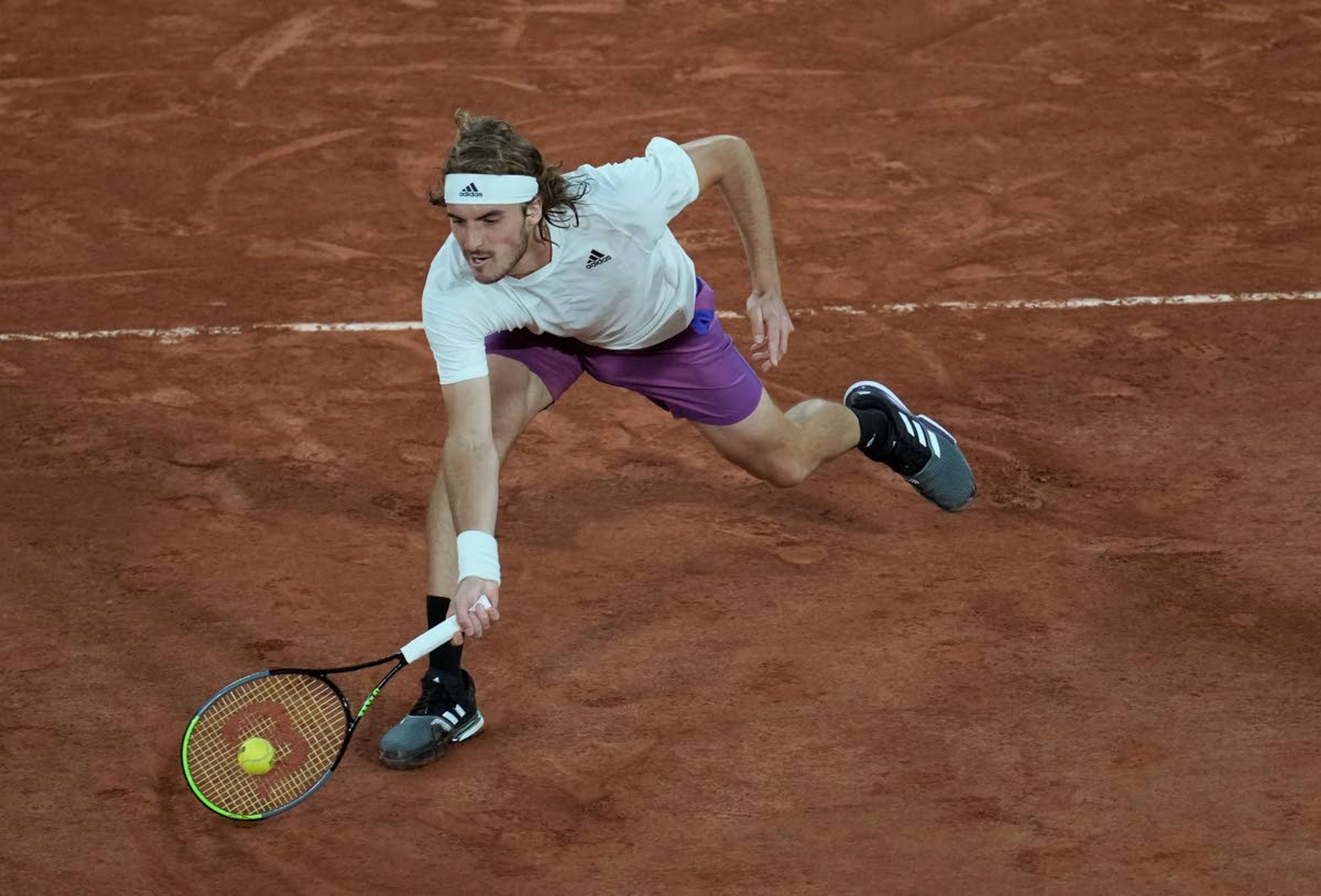 Stefanos Tsitsipas of Greece plays a return to United States' John Isner during their third round match on day 6, of the French Open tennis tournament at Roland Garros in Paris, France, Friday, June 4, 2021. (AP Photo/Christophe Ena)