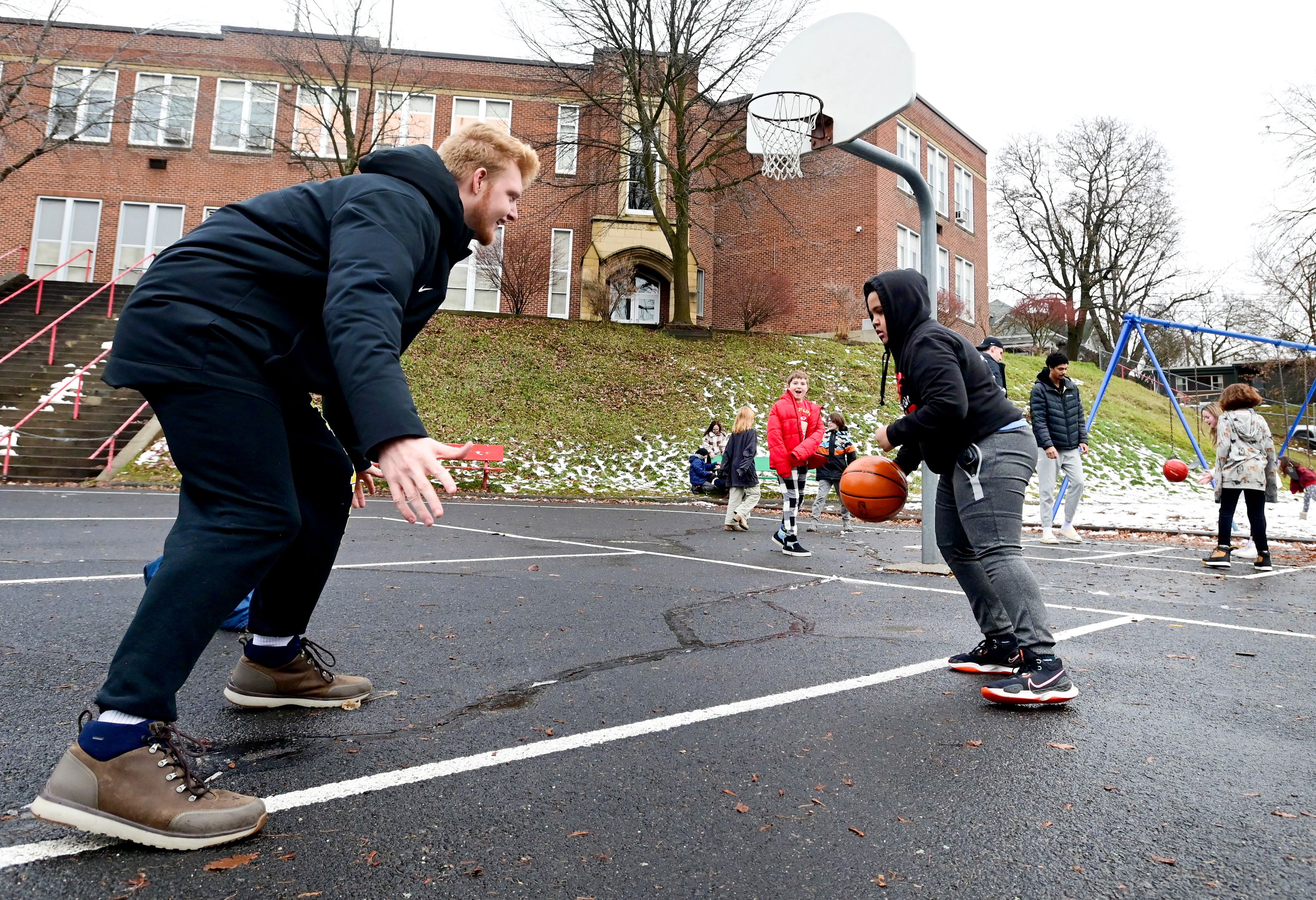 Idaho Vandal Kyson Rose guards fifth grader Kalid, right, as they play a pick-up game during recess at John Russell Elementary School in Moscow on Monday. The Vandals visit with students a few times each month during lunch and recess as mentors.