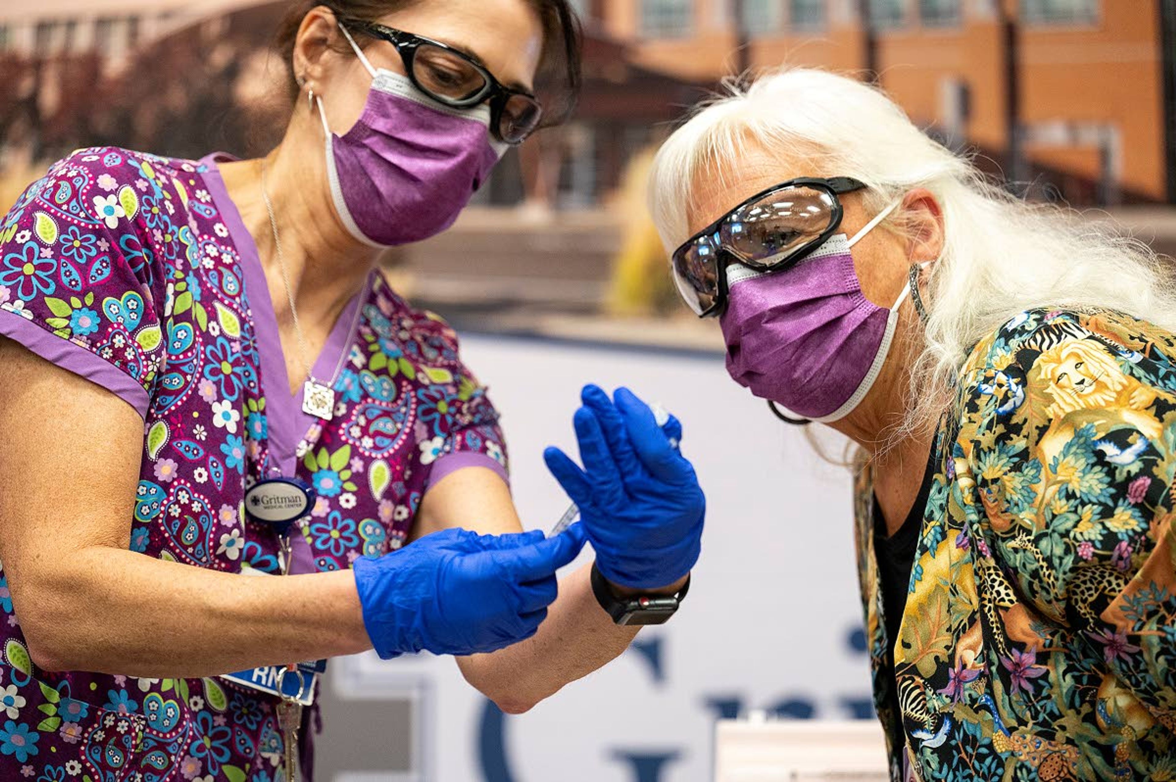 Gritman Medical Center registered nurses with the Occupational Health Department Shelly Frei (left) and Susie Christopher prepare prepare the COVID-19 vaccine for registered nurse Nina Benichou’s inoculation on Friday in Moscow. Benichou was the first person at Gritman to get vaccinated. The medical center will be inoculated dozens of other front line employees throughout the afternoon.,