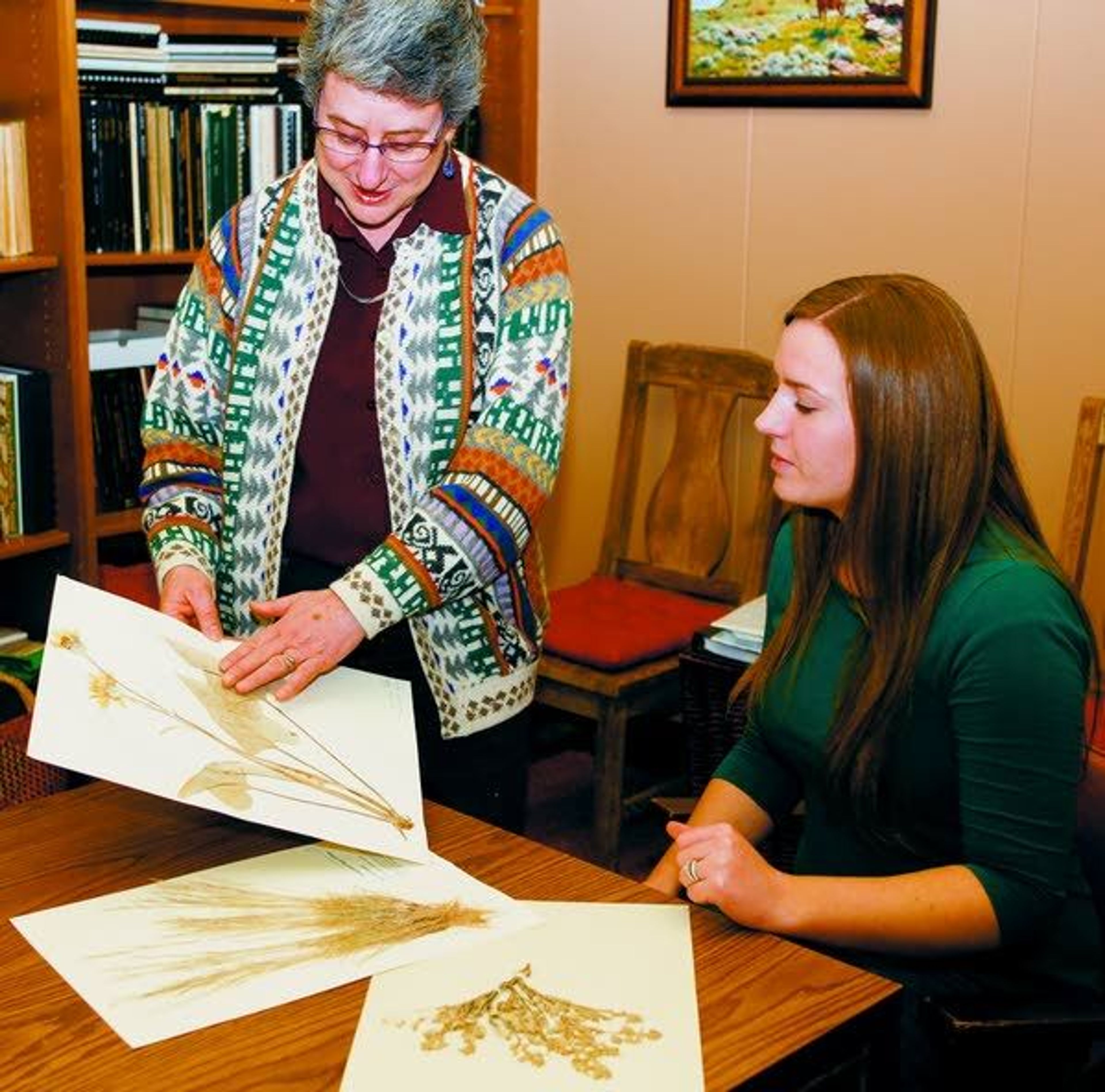 University of Idaho Professor Karen Launchbaugh, left, helps senior Allison Davenport with identifying plant species native to Idaho on Thursday in Moscow.