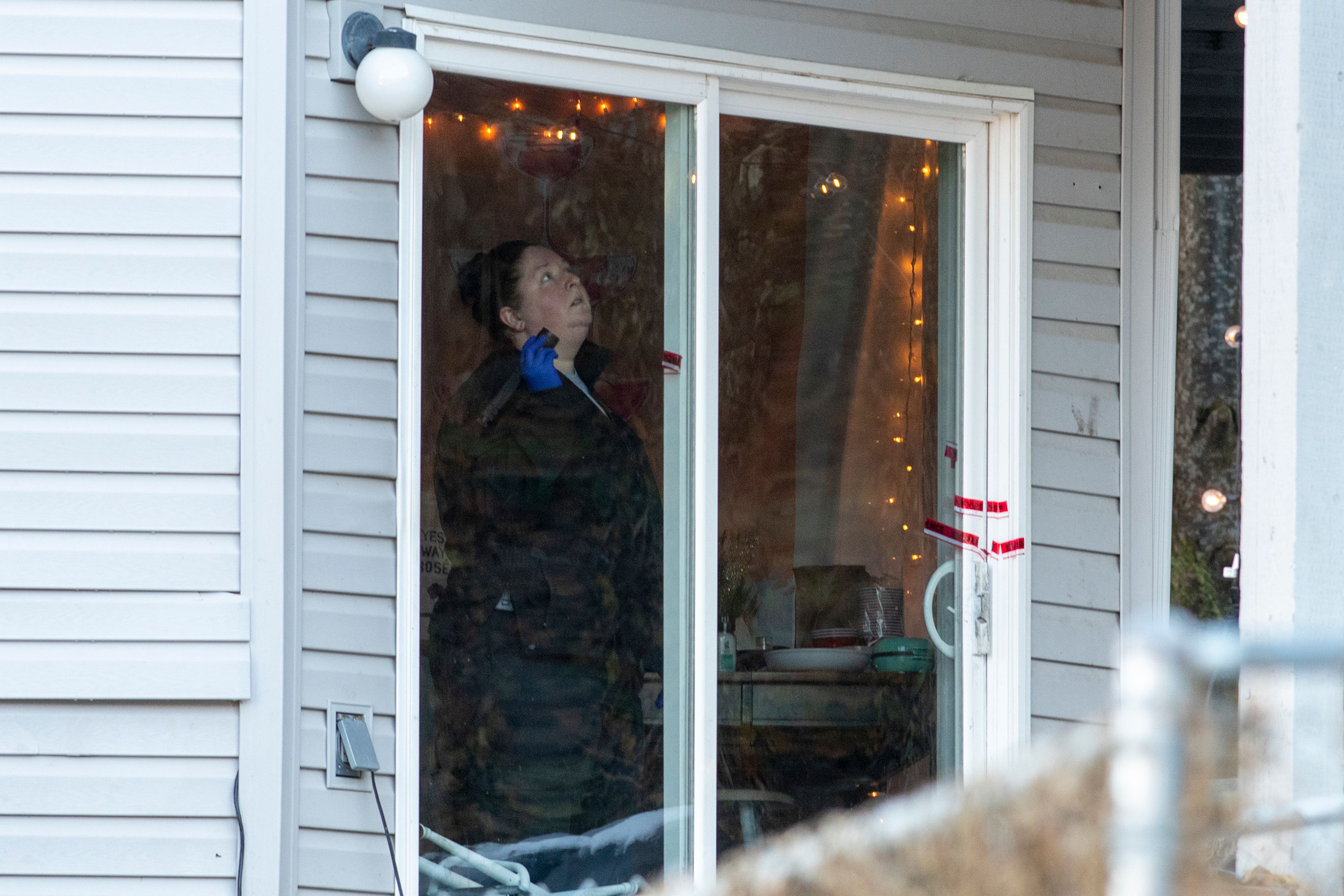 A member of the Idaho State Police forensic team investigates Friday at a home where four University of Idaho students were recently murdered over the weekend in Moscow.