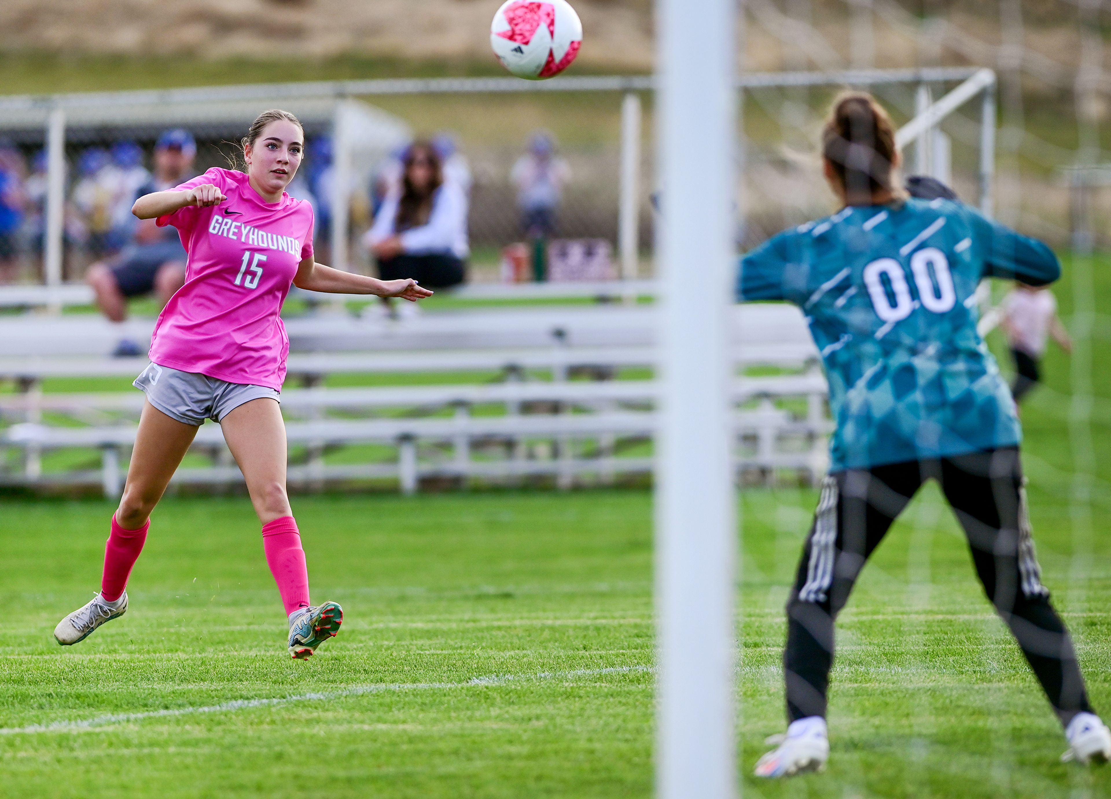 Pullman freshman Vicky Villarino watches her shot on goal near Deer Park goalie Samantha Fausti Thursday in Pullman.,