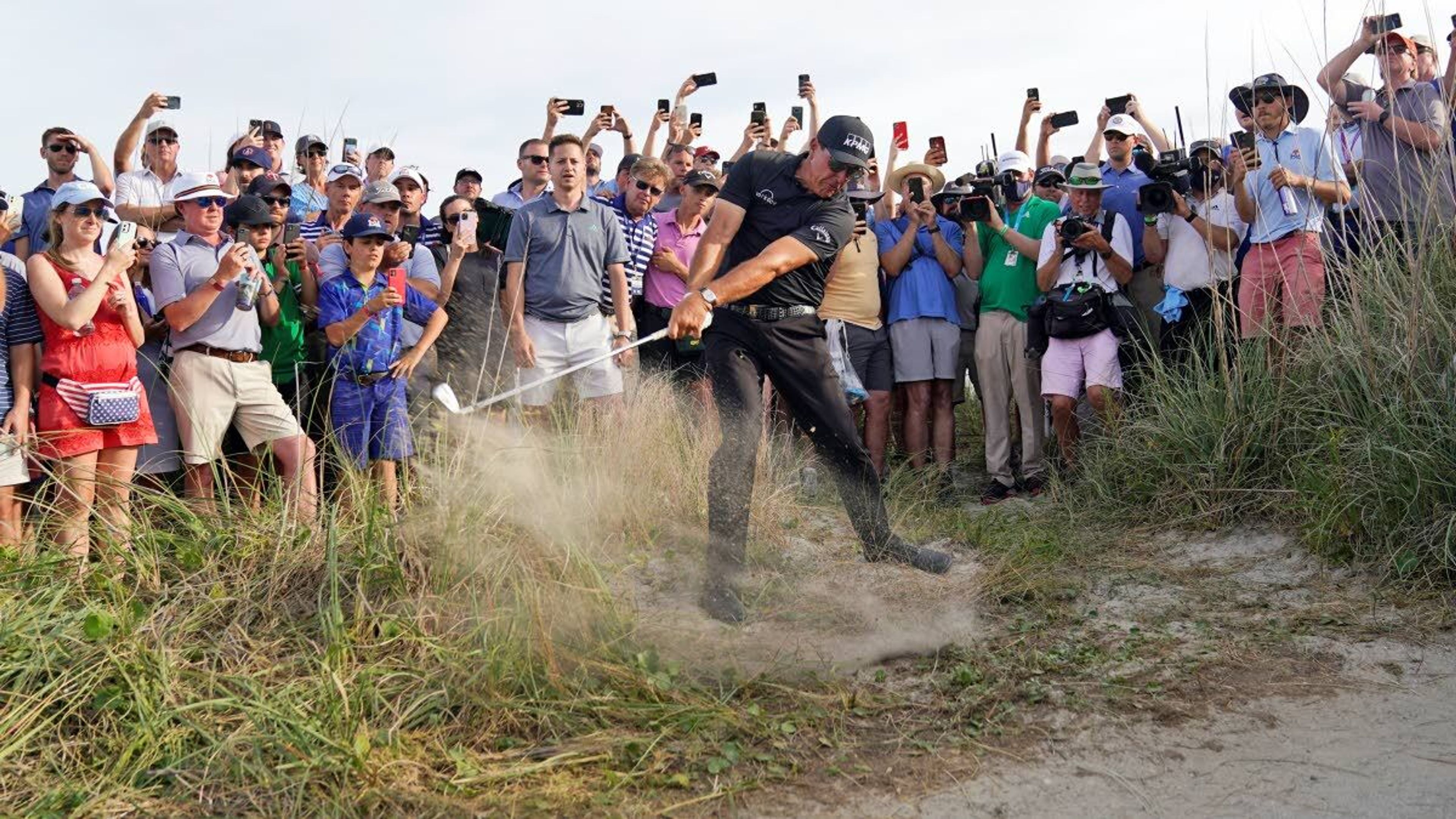 Phil Mickelson hits his second shot from the rough on No. 16 during Saturday’s third round of the PGA Championship on the Ocean Course in Kiawah Island, S.C.