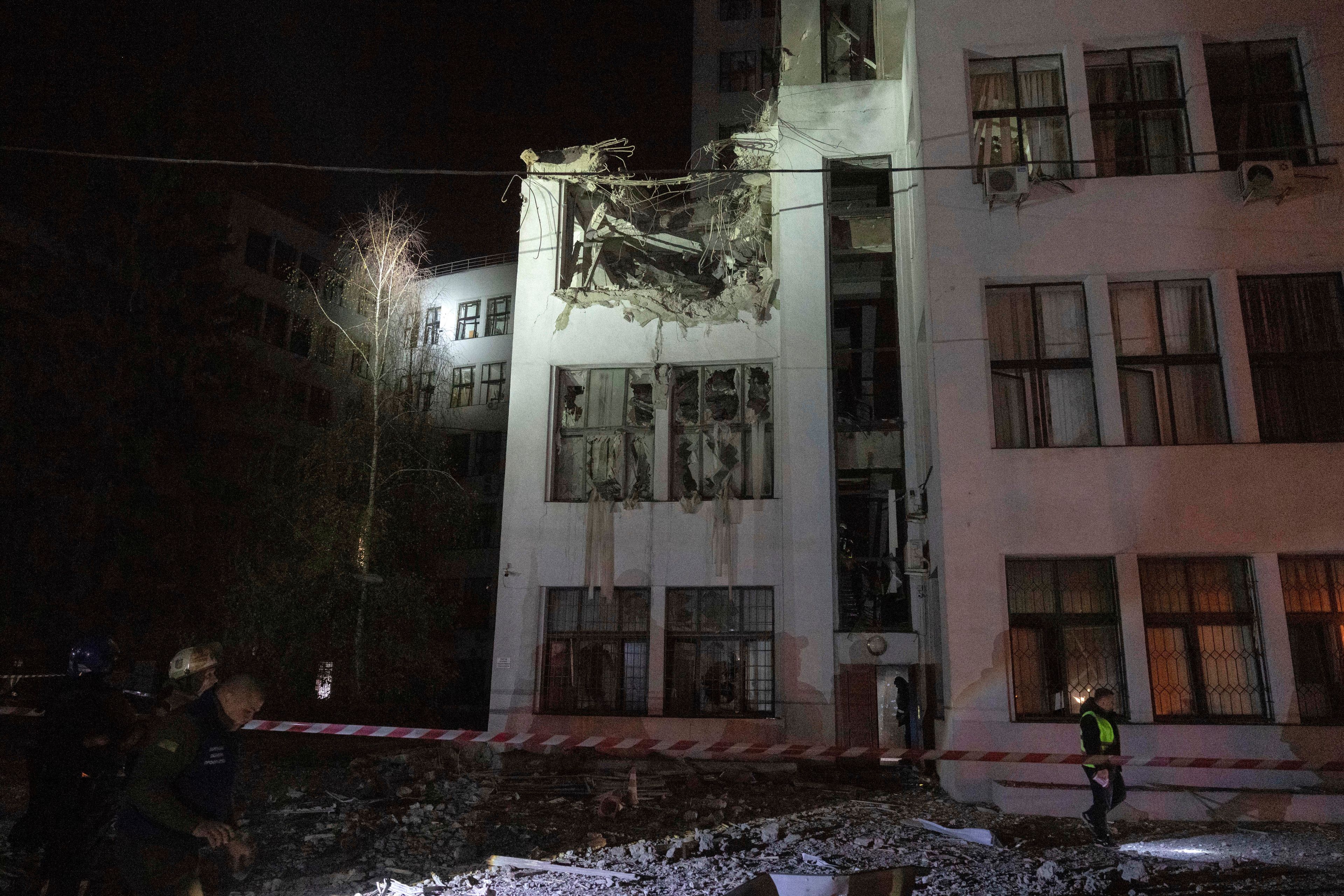 Firefighters inspect the damaged office building after it was hit by Russian aerial guided bombs in central Kharkiv, Ukraine, Monday, Oct. 28, 2024. (AP Photo/Efrem Lukatsky)