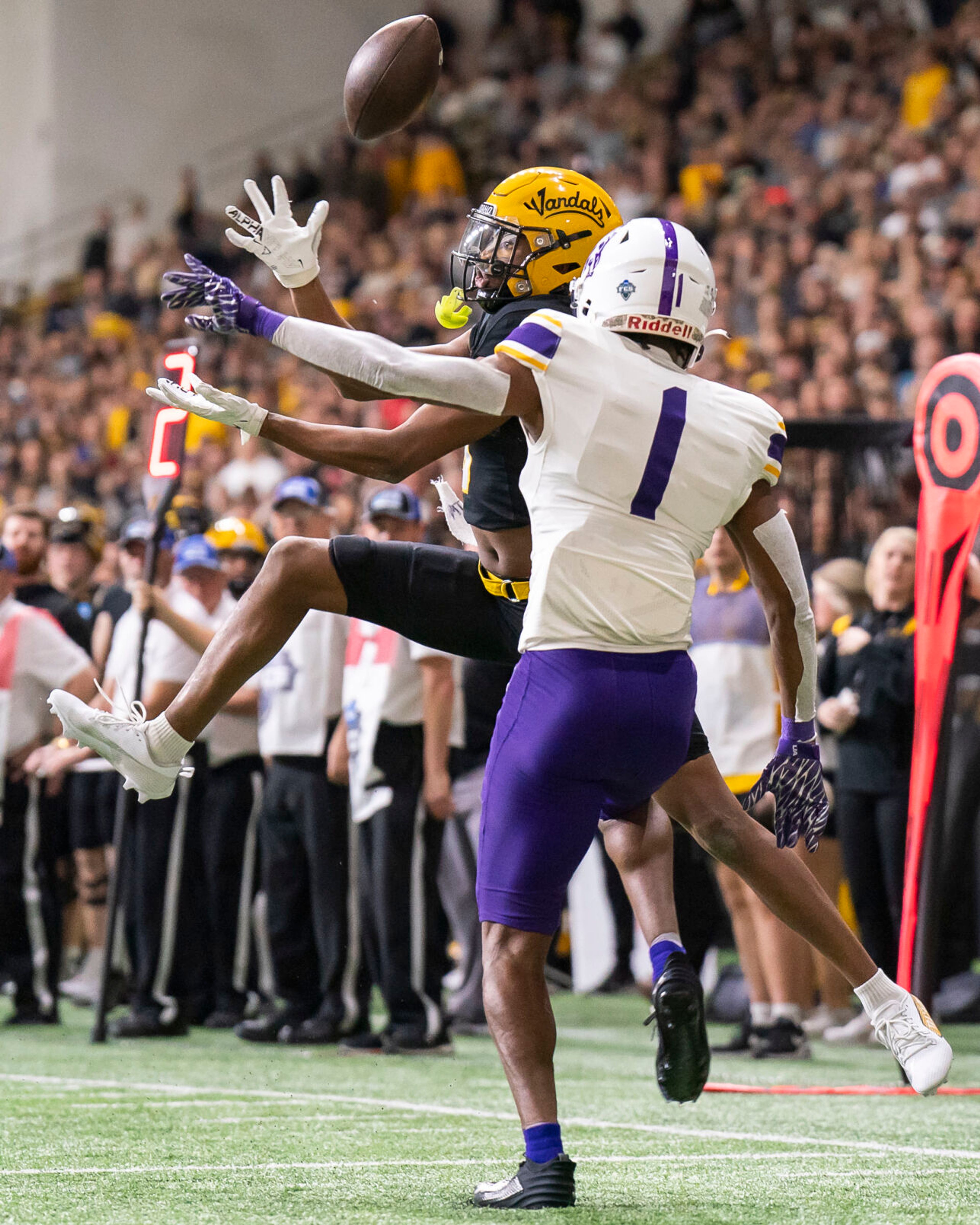 Idaho Vandals wide receiver Terez Traynor, left, bobbles the ball during their game against Albany in the third round of the 2023 Division I FCS Football Championship on Saturday inside the Kibbie Dome in Moscow.