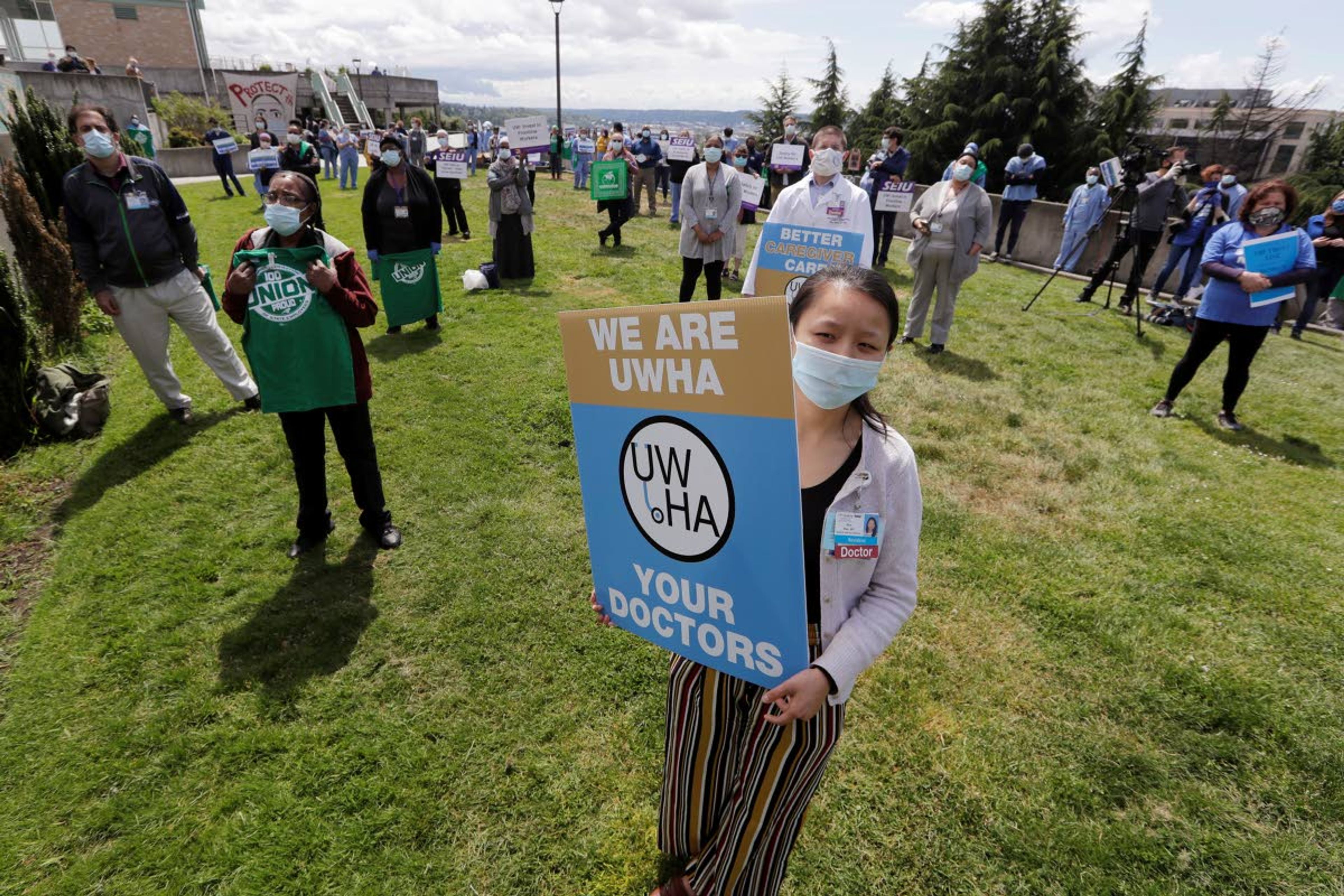 Associated PressHealth care workers stand about 6 feet apart at Harborview Medical Center, a part of UW Medicine, during a noon hour demonstration asking management to do more to protect staff, patients and the public amid the COVID-19 pandemic Thursday in Seattle.