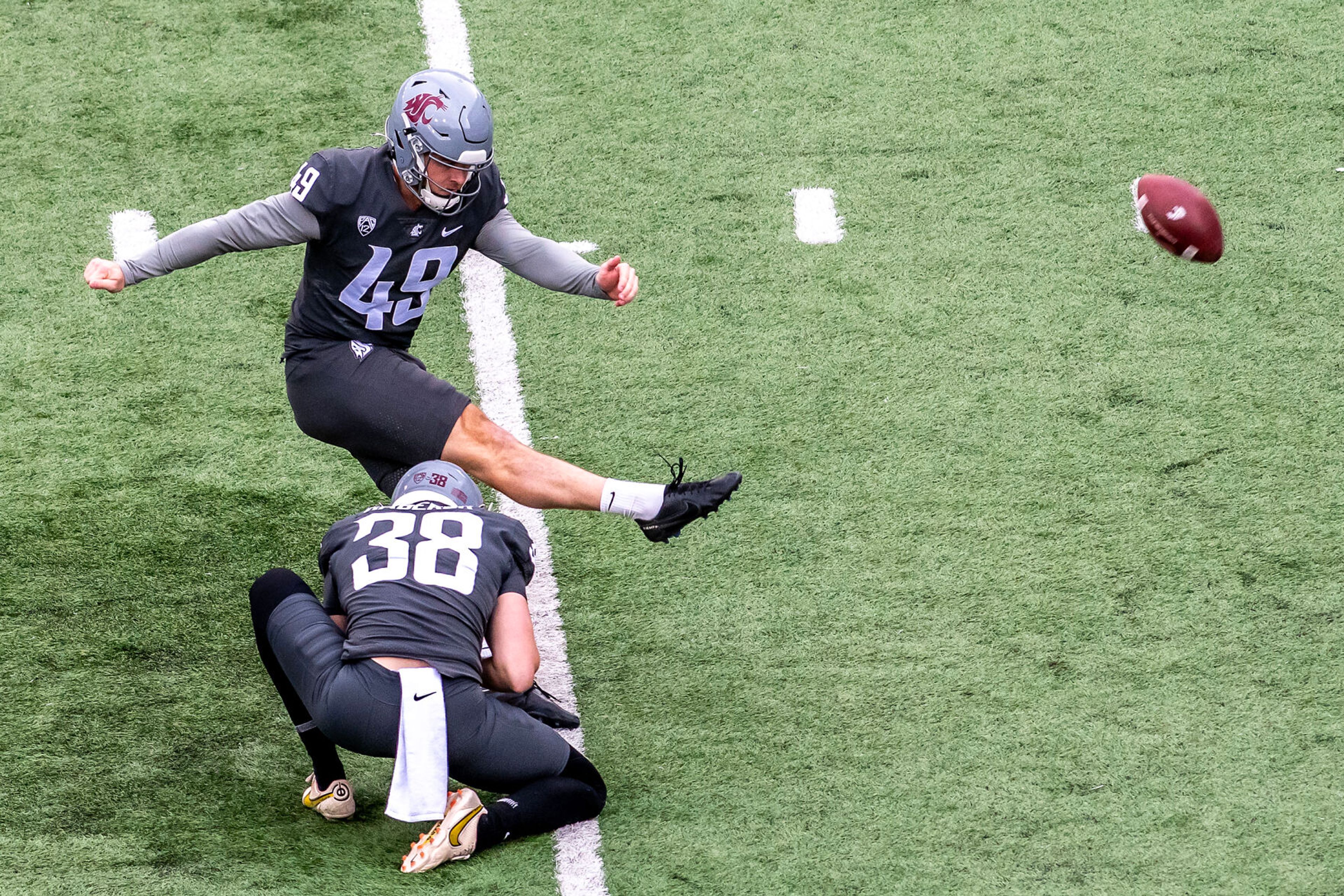 Kicker Dean Janikowski hits a field goal in a quarter of the Crimson and Gray Game at Washington State University in Pullman.