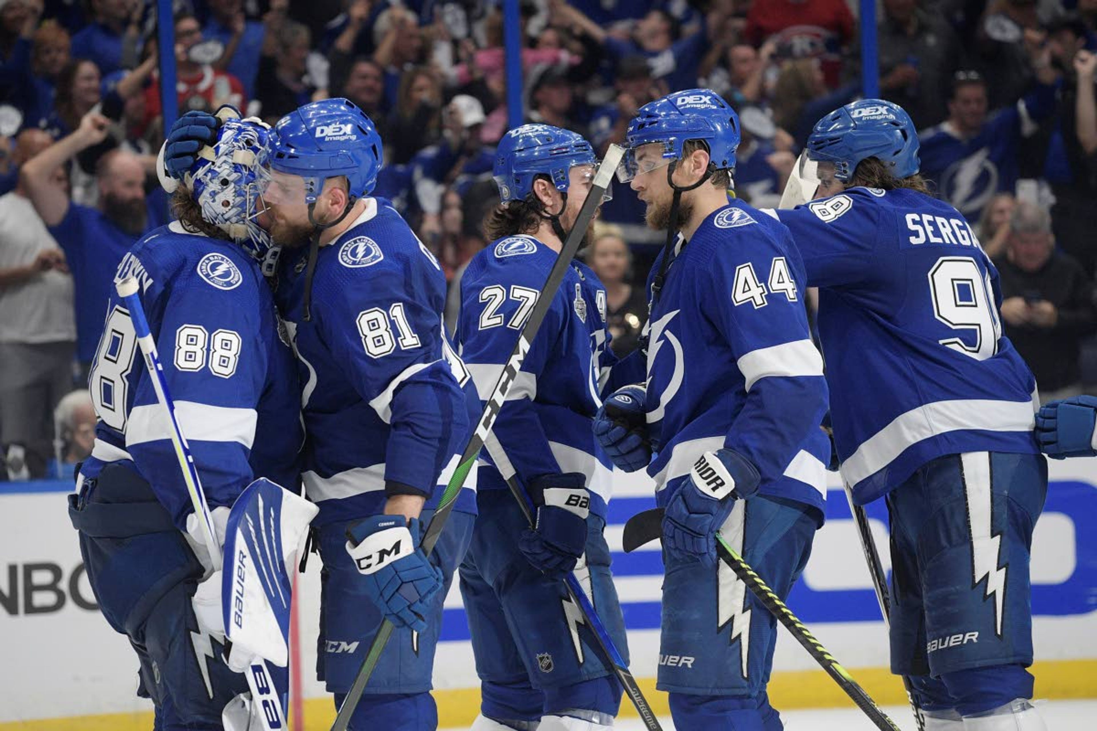 Tampa Bay Lightning goaltender Andrei Vasilevskiy (88) is congratulated by defenseman Erik Cernak (81) after the third period in Game 1 of the NHL hockey Stanley Cup finals, against the Montreal Canadiens Monday, June 28, 2021, in Tampa, Fla. The Lightning won 5-1. (AP Photo/Phelan Ebenhack)