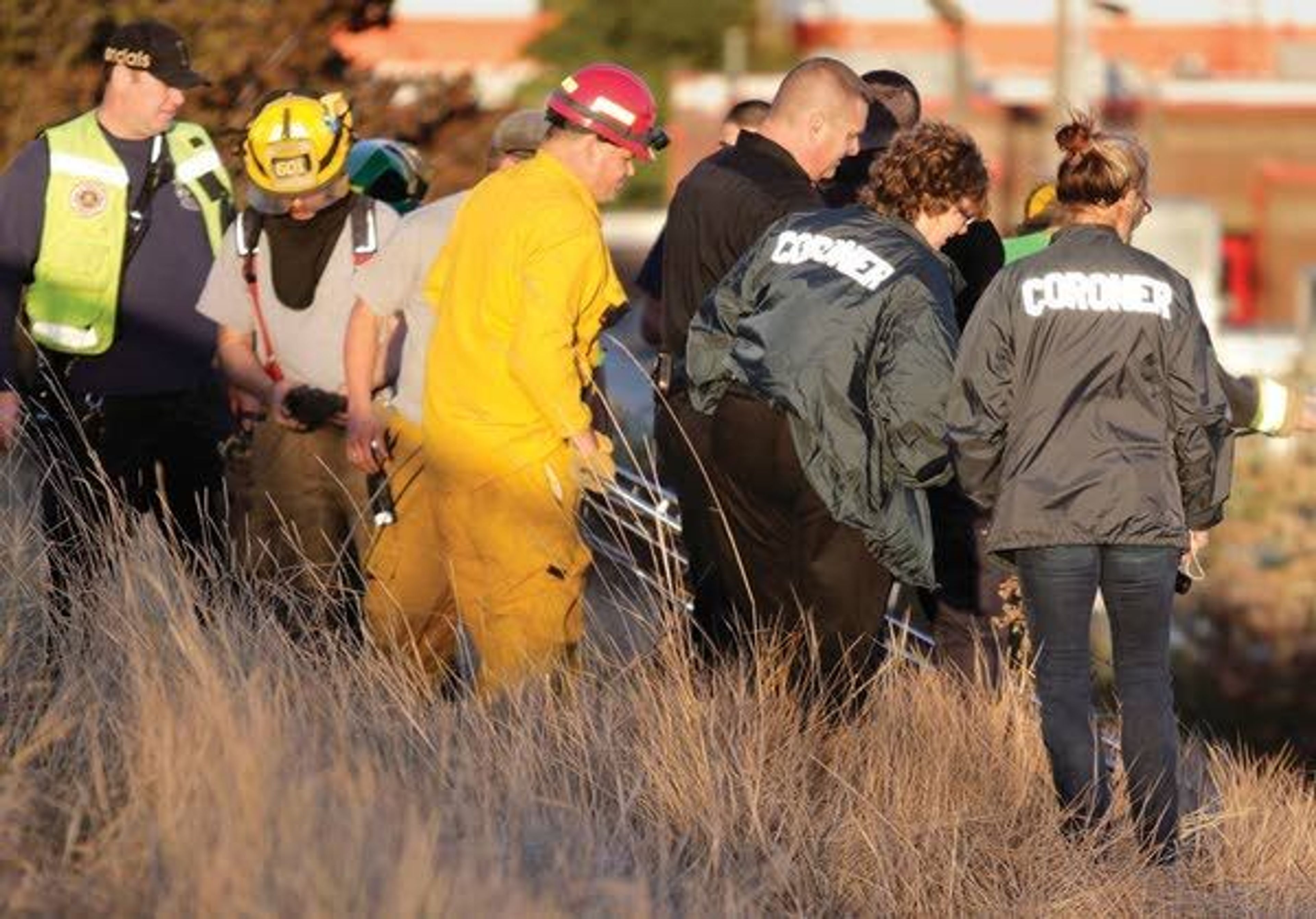 Latah County Coroner Cathy Mabbutt, second from right, works at the scene where a man was found dead Aug. 30 in Moscow.