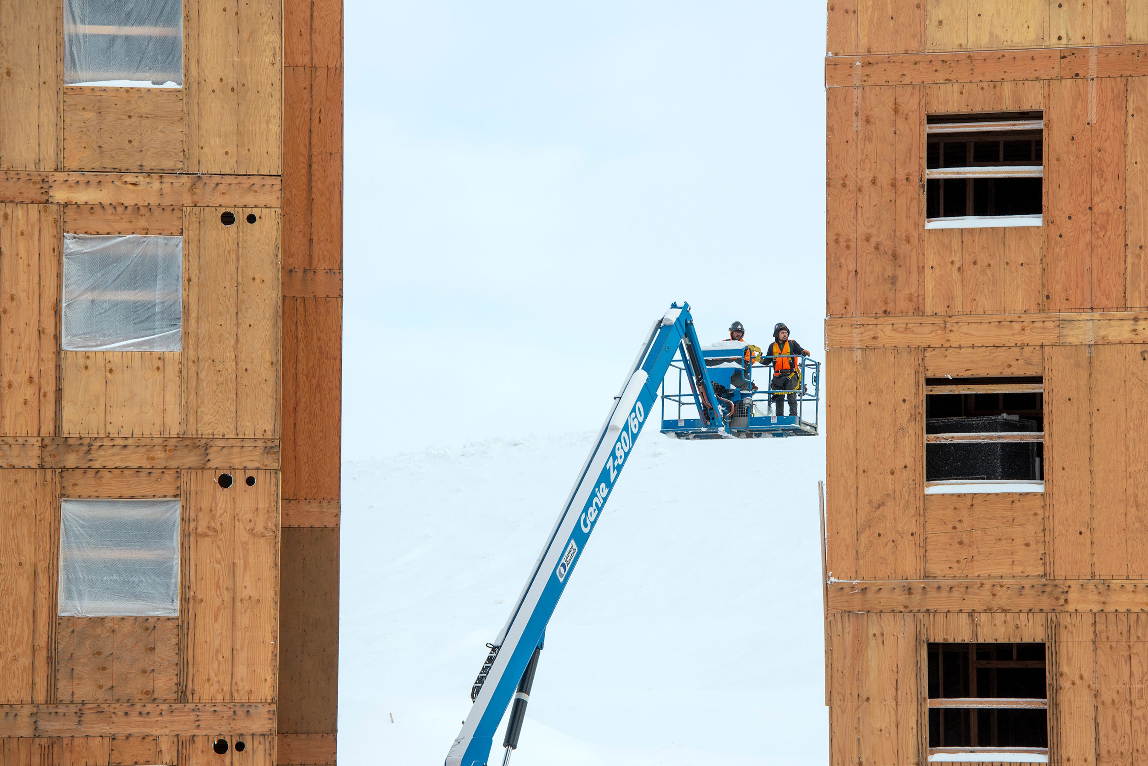 Construction workers in a boom lift are framed in-between two buildings along North Fairway Road in Pullman on Wednesday.