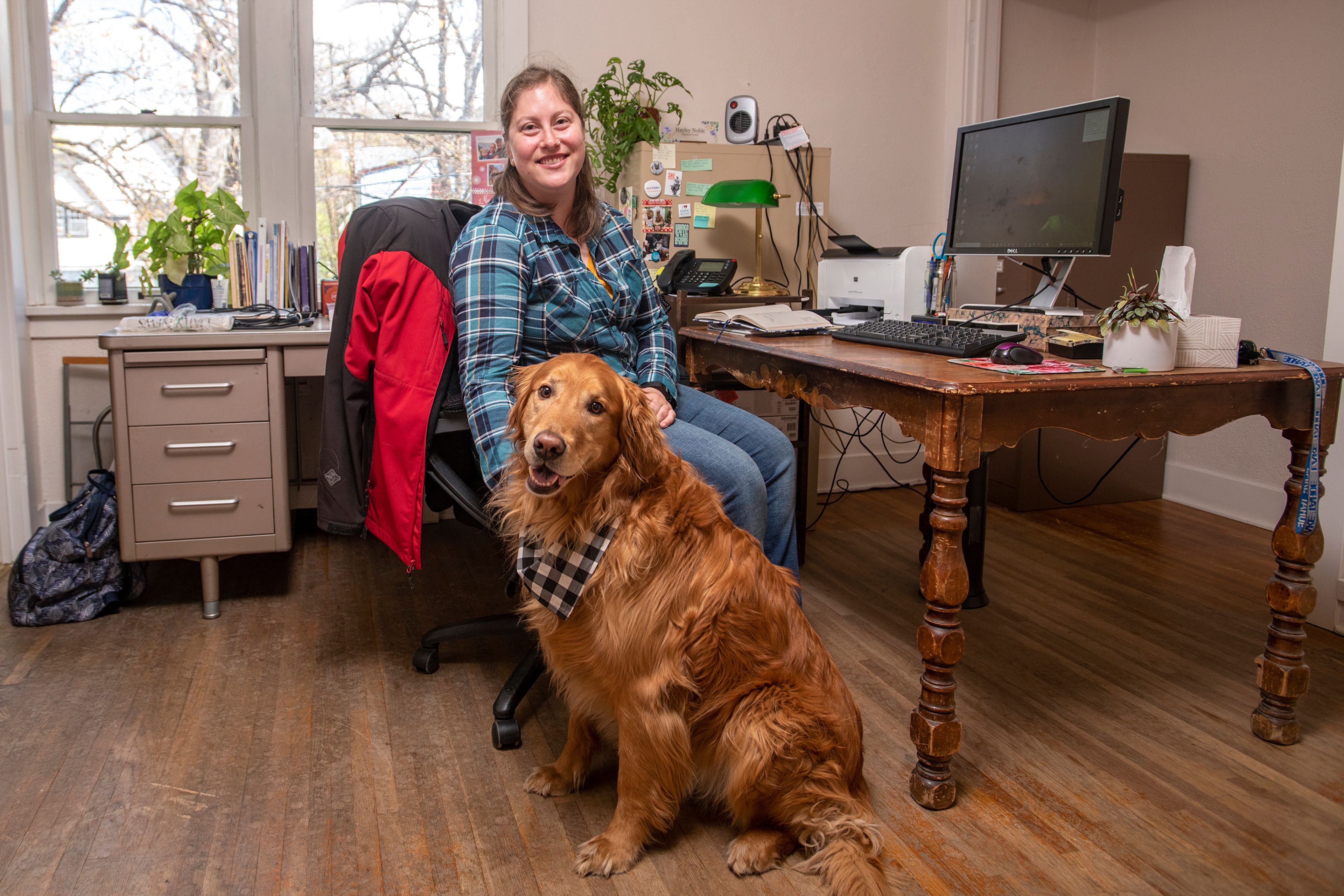 Hayley Noble, executive director of the Latah County Historical Society, poses for a portrait in her office with her golden retriever, Indy, 5, in Moscow on Friday. Noble said Indy was named after Indiana Jones.