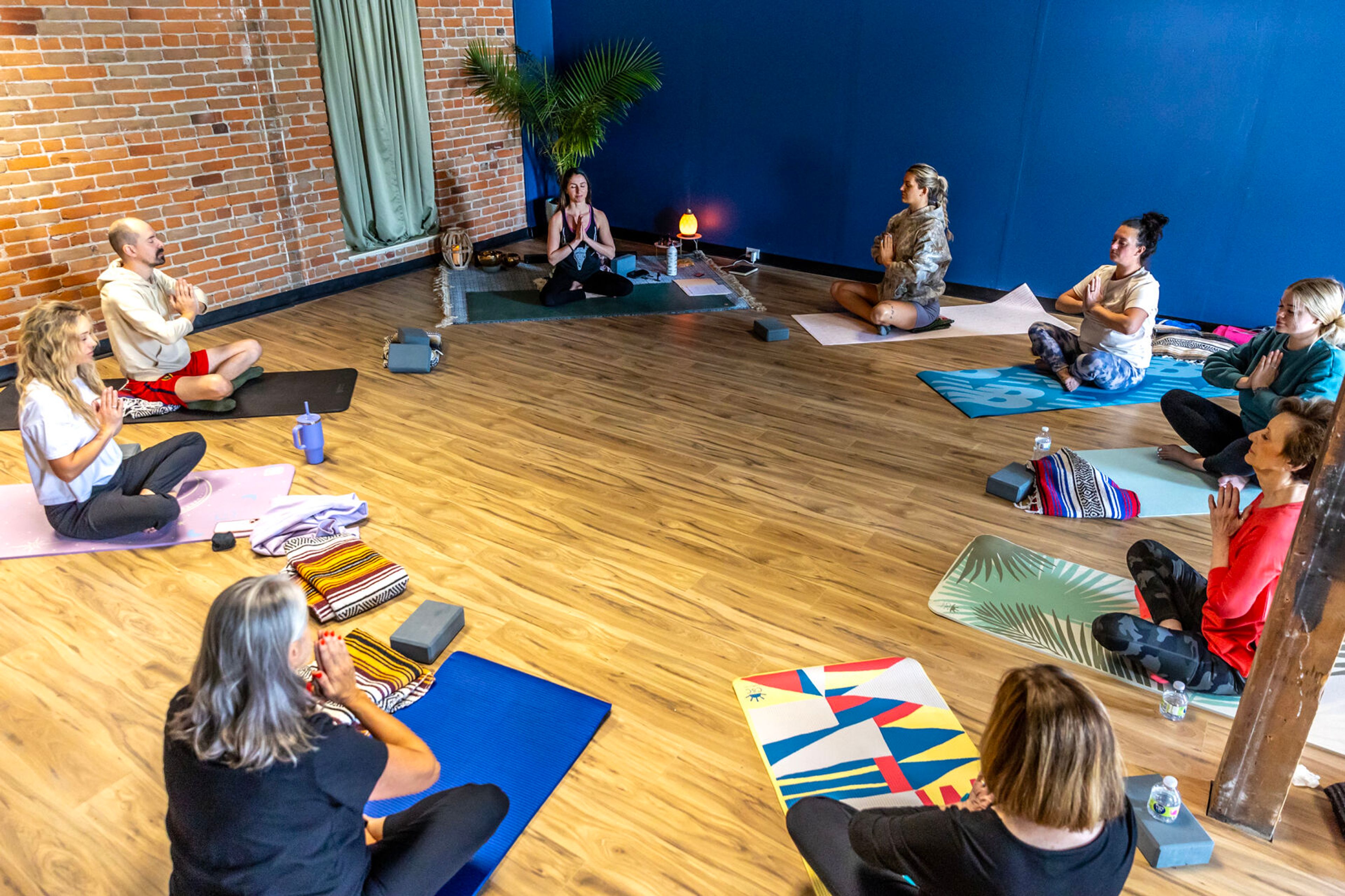 Beatriz Merl leads a group in prayer pose at Bea You Yoga Wednesday, May 8, in Lewiston.