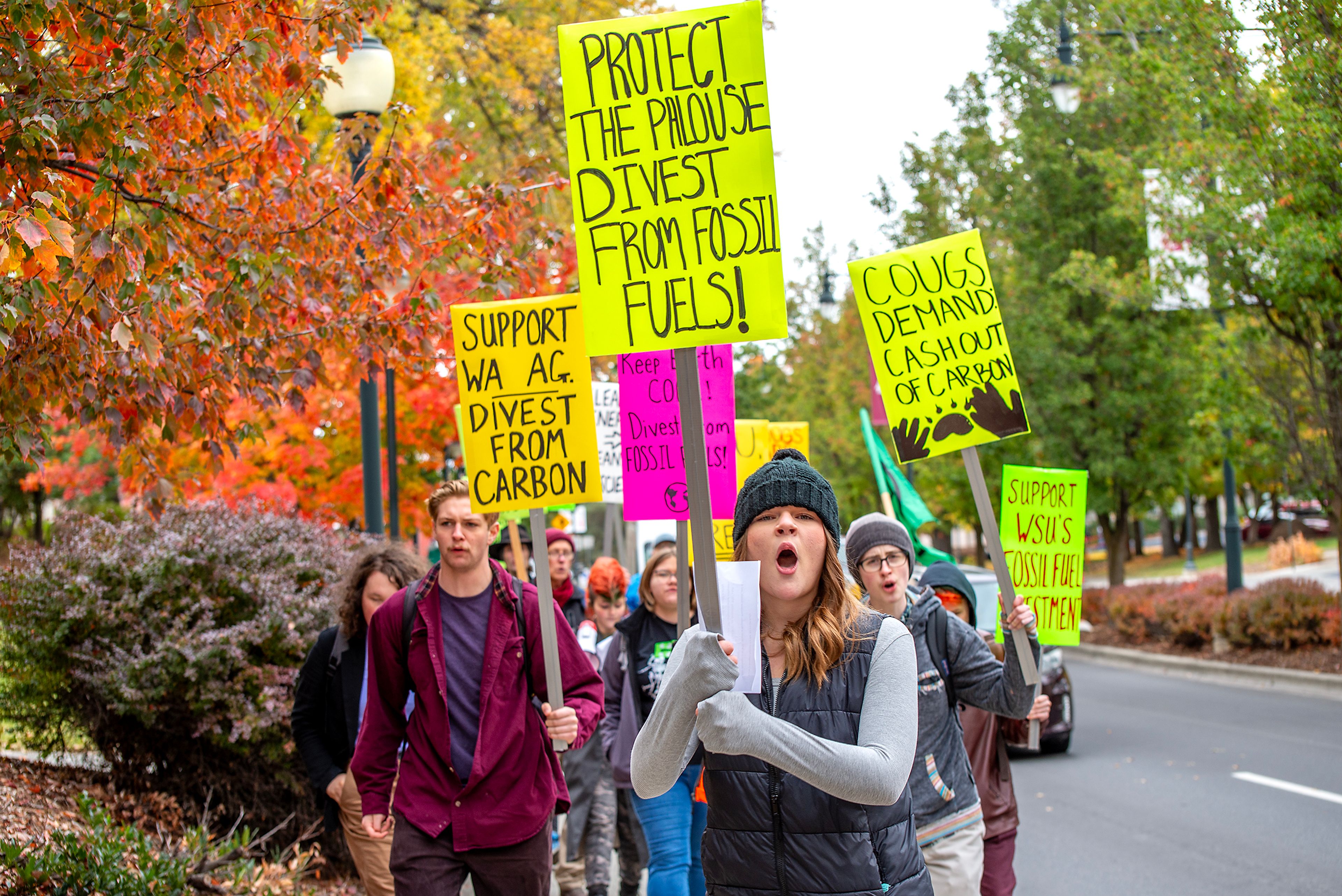 Washington State University student Lyric Lynch leads people through campus Wednesday in a protest calling on the college to divest from fossil fuels in Pullman.