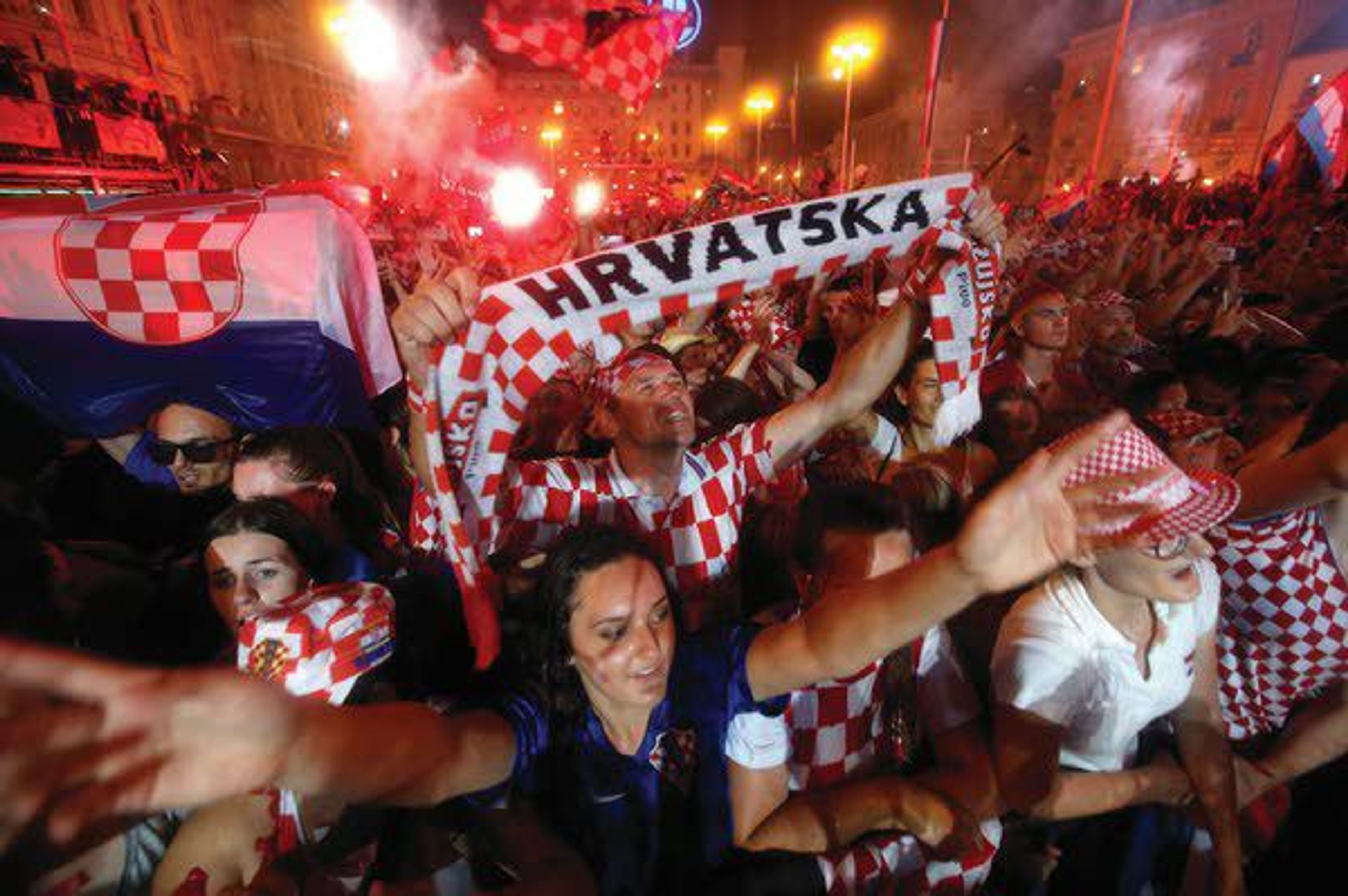 Croatia national soccer team members are welcomed with their national flags waved upon arrival Monday in Zagreb, Croatia. Euphoria gave way to a mixture of disappointment and pride for Croatia fans after their national team lost to France in its first ever World Cup final.