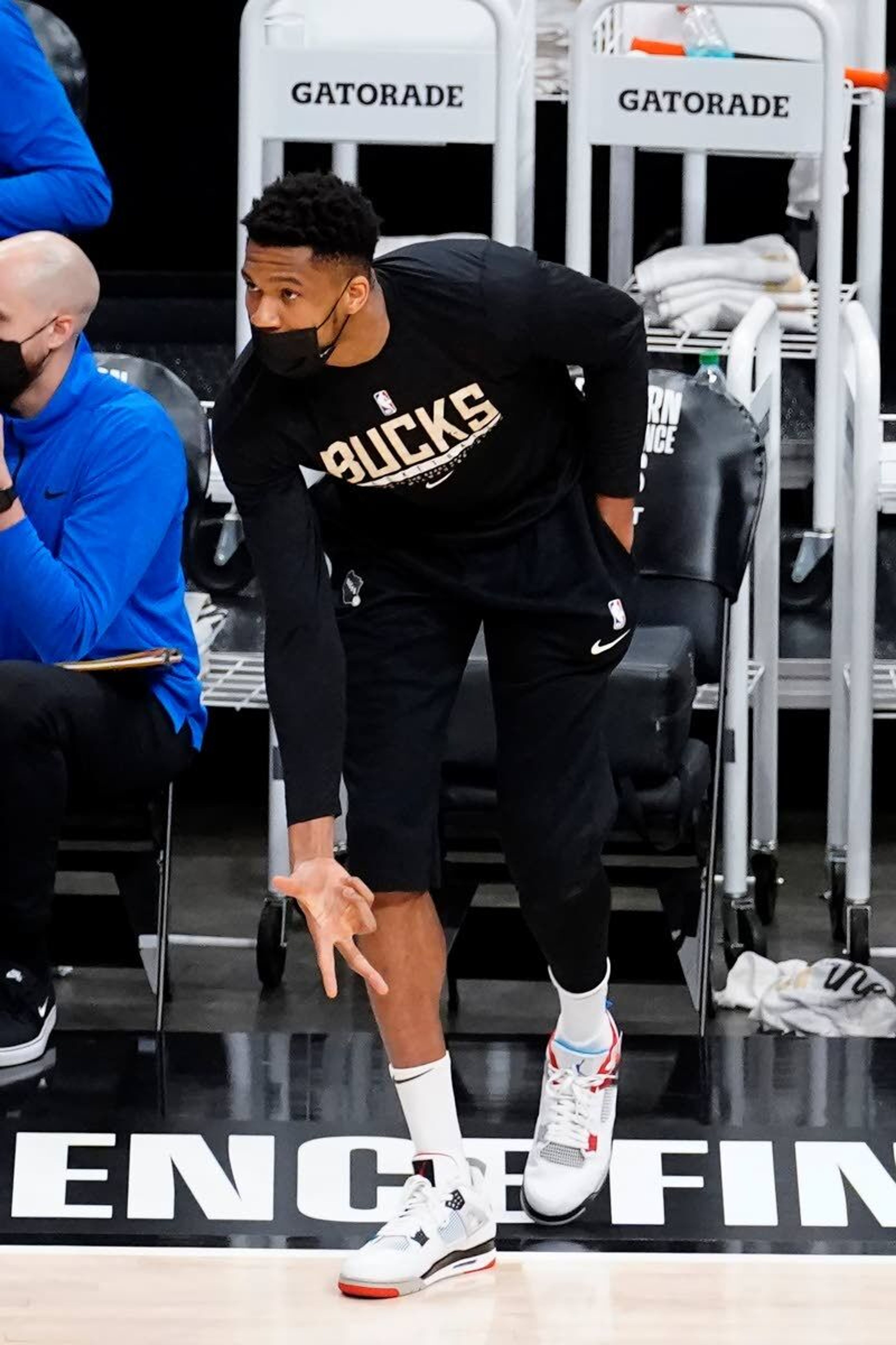 Injured Milwaukee Bucks forward Giannis Antetokounmpo reacts after a Milwaukee basket during the first half in Game 6 of the Eastern Conference finals in the NBA basketball playoffs against the Atlanta Hawks, Saturday, July 3, 2021, in Atlanta. (AP Photo/John Bazemore)