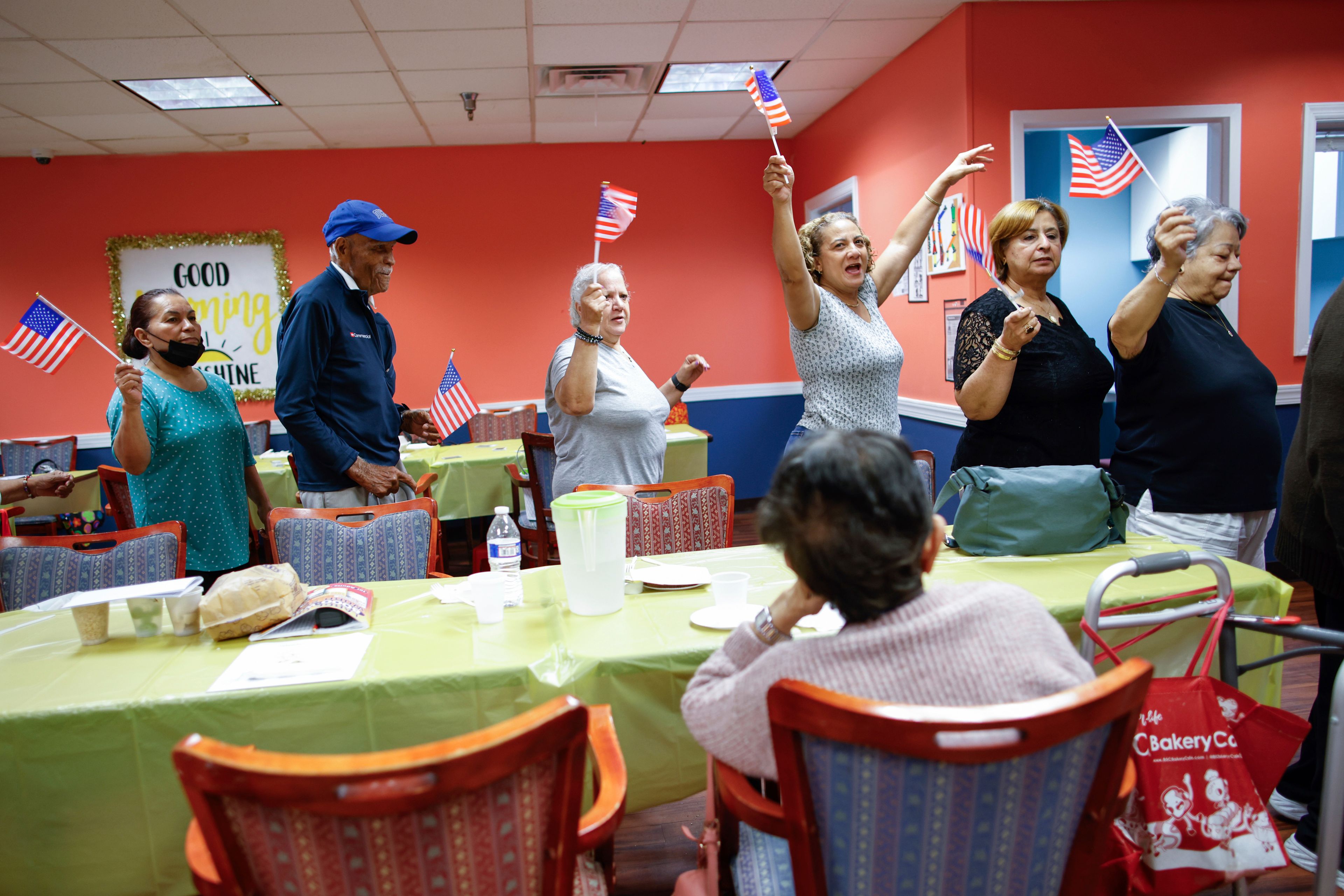 People march in a line as they take part in a multicultural parade at Sunshine Adult Day Center in Bergenfield, N.J., Monday, Aug. 26, 2024. (AP Photo/Kena Betancur),