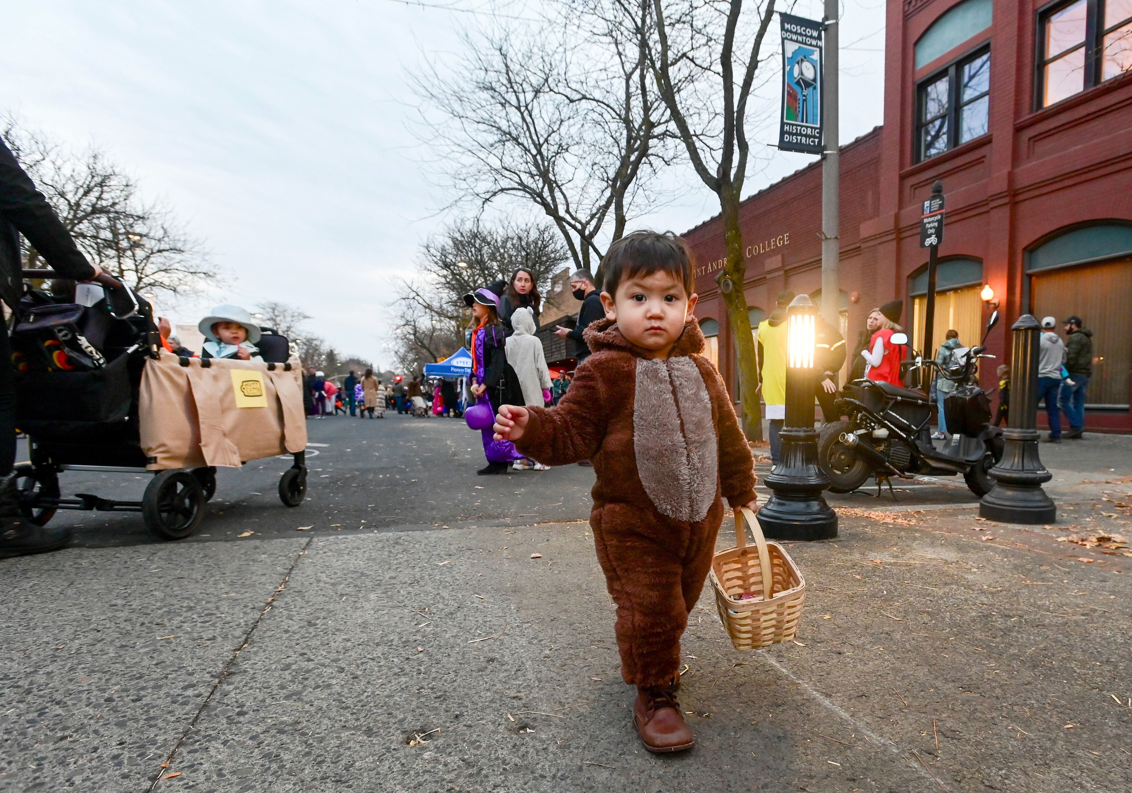 Noah Litwin walks along Main Street in a fuzzy costume, candy basket in hand, during Moscow’s Downtown Trick-or-Treat on Tuesday.