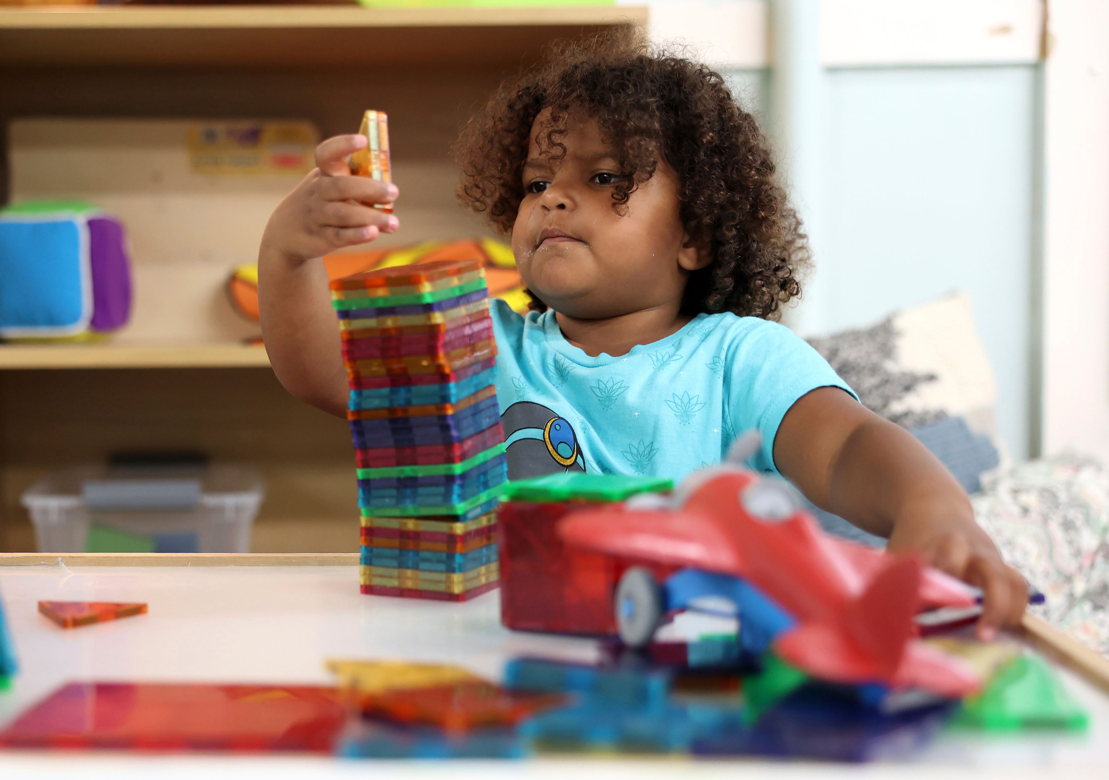 Winnie VanDusen, 3, plays with blocks at Bumble Art Studio day care center in Astoria, Ore., Friday, Sept. 2, 2022. From Oregon to New York, demand for child care far exceeds supply. Families are growing increasingly desperate as providers deal with staffing shortages exacerbated by the coronavirus pandemic as well as historically low pay worsened by inflation. (AP Photo/Craig Mitchelldyer)