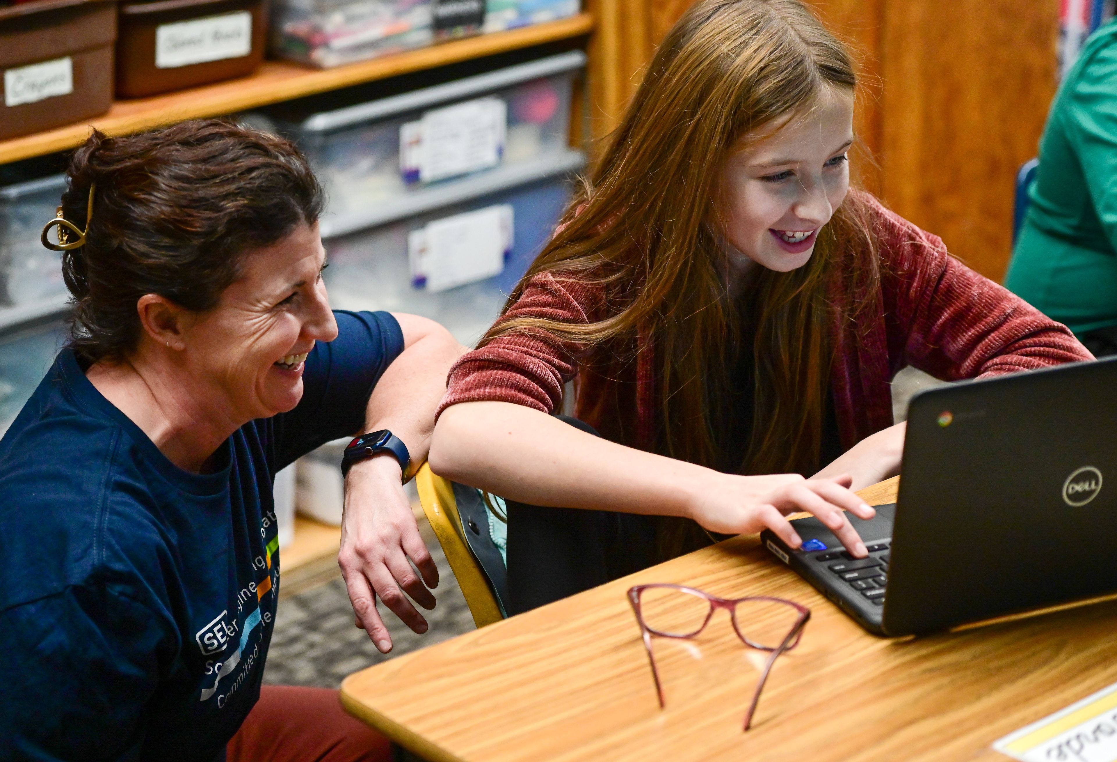 Potlatch Elementary principal Jill Diamond, left, works with fifth-grader Emmalie Forde, 10, on a coding activity during a visit from Schweitzer Engineering Laboratories engineers for a day-long Hour of Code event on Tuesday.