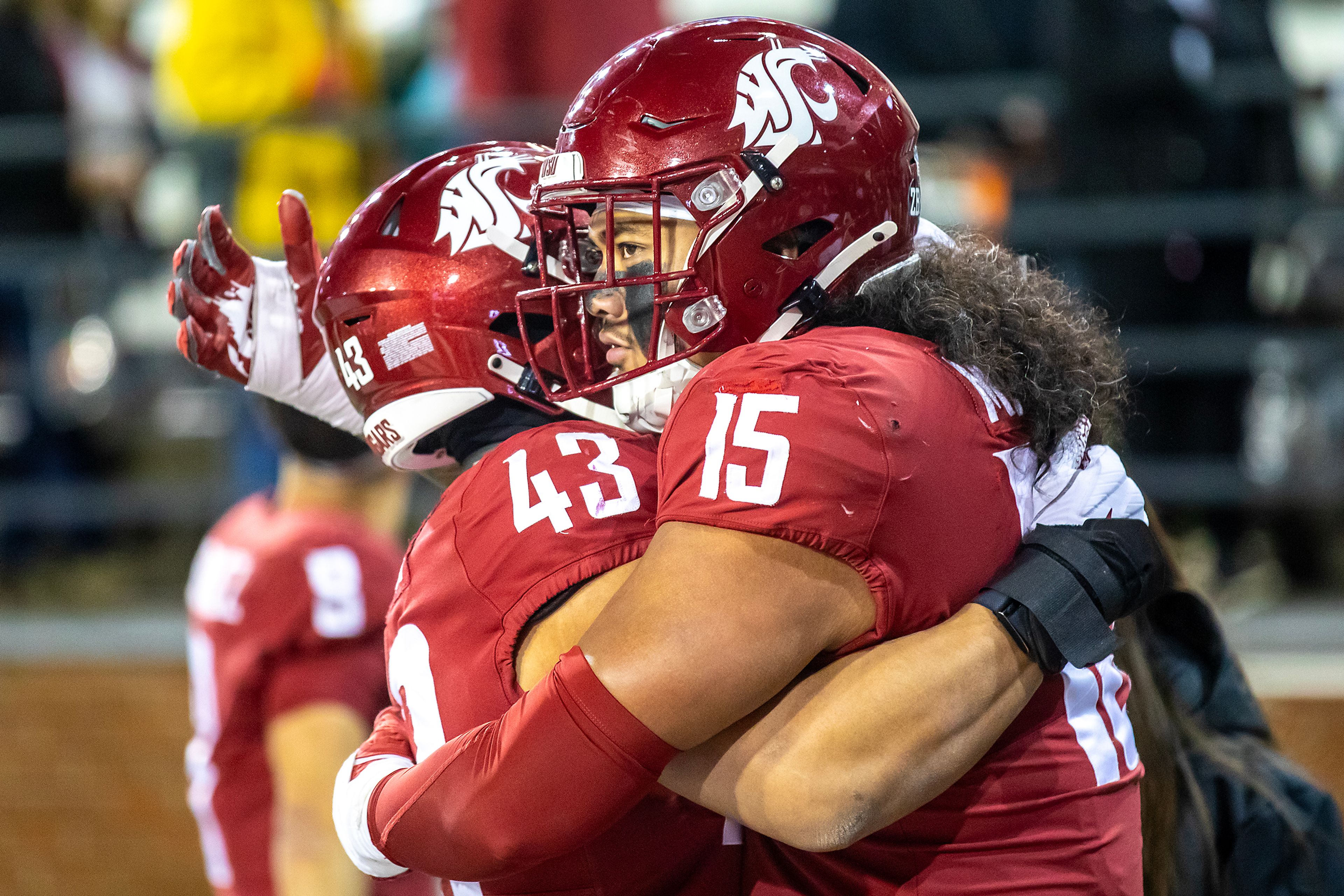 Washington State edge Nusi Malani embraces teammate Wesley Steiner after losing to Wyoming in a college football game on Saturday, at Gesa Field in Pullman. Wyoming defeated Washington State 15-14.