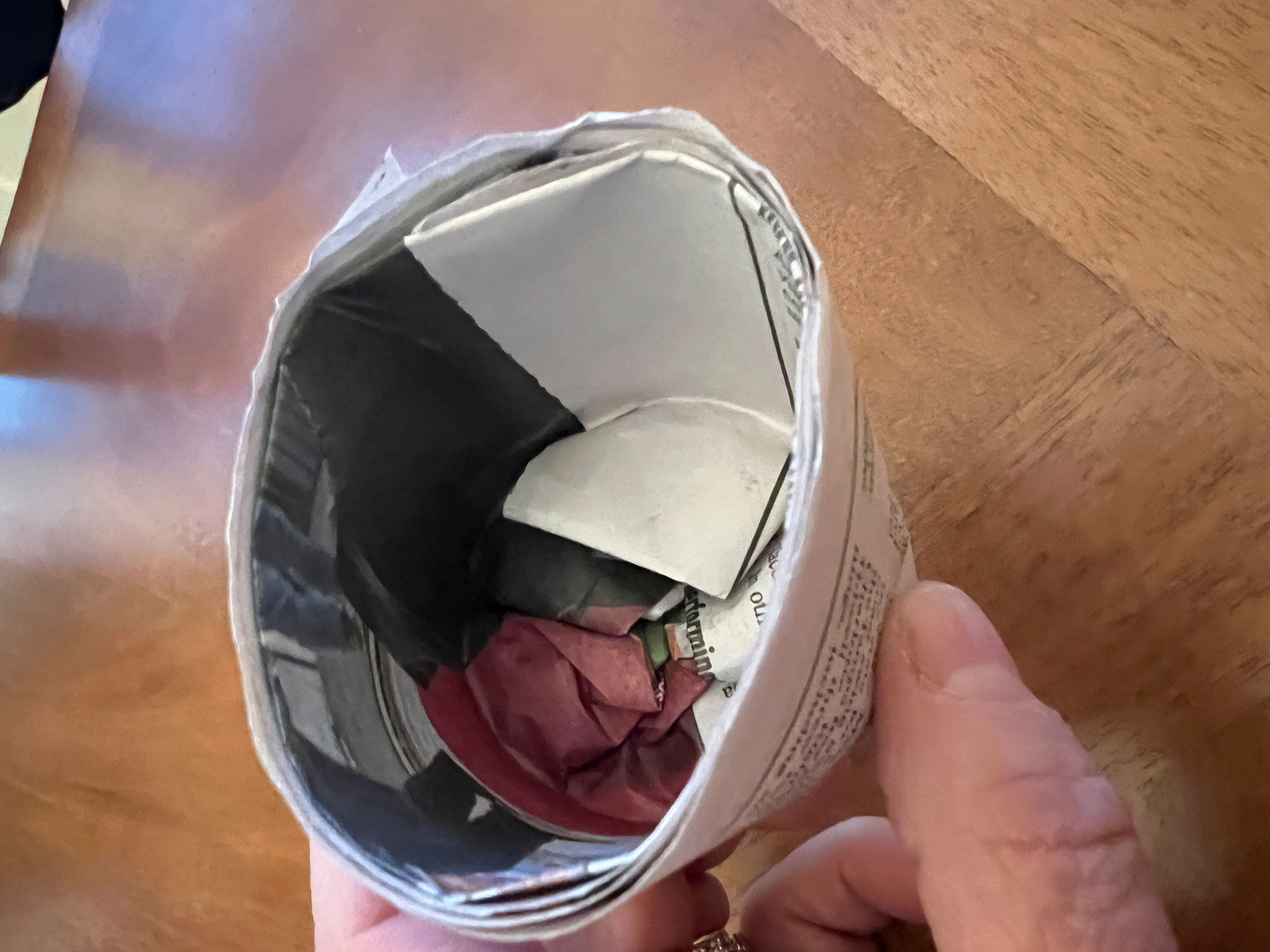 This March 2, 2025, image shows a step in making a DIY seed pot from a sheet of newspaper. (Jessica Damiano via AP)