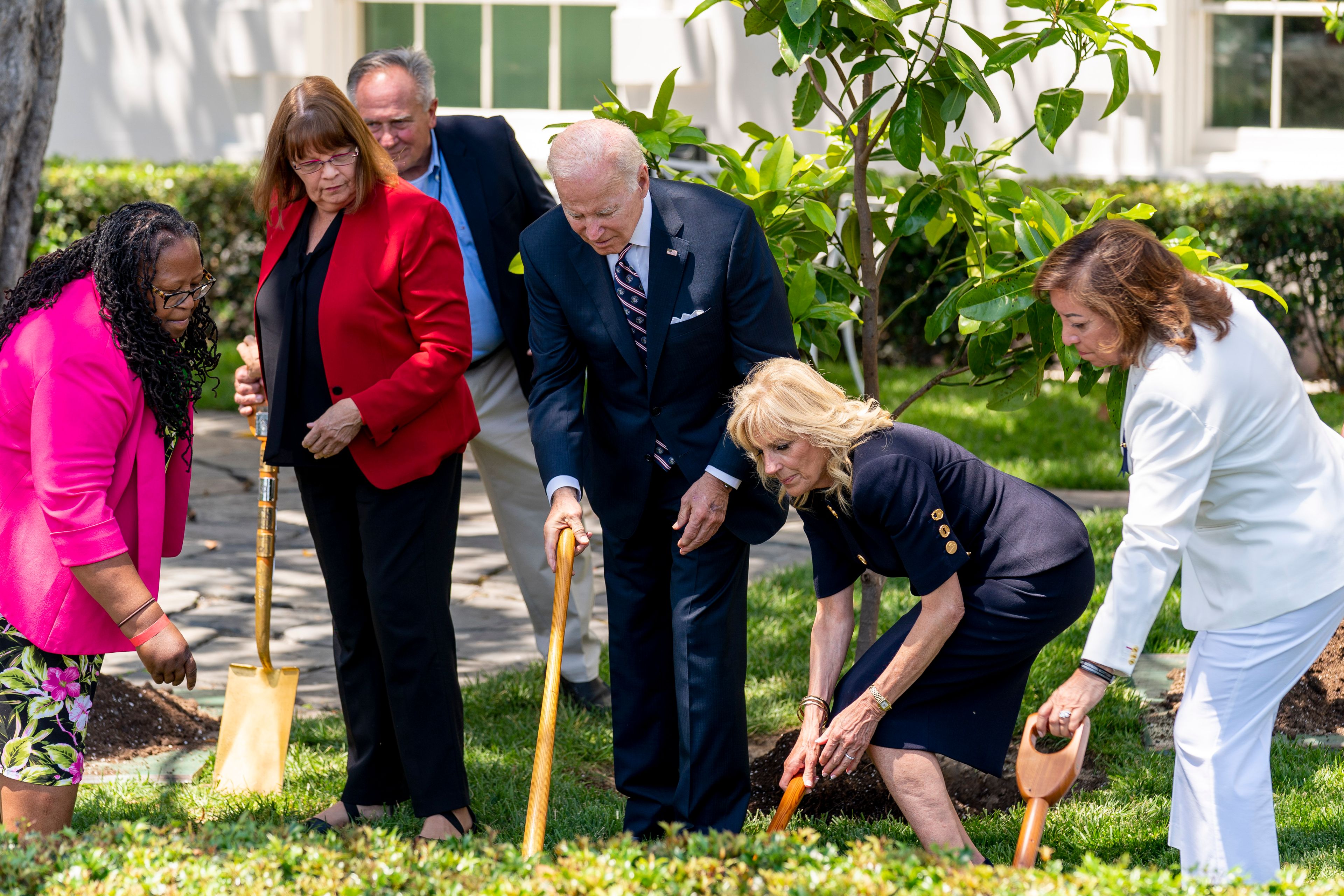 President Joe Biden and first lady Jill Biden, joined by surviving families of service members, participates in a magnolia tree planting ceremony on the South Lawn of the White House in Washington, Monday, May 30, 2022. The new tree was grown from a seed from the original magnolia planted on the South Lawn by President Andrew Jackson. (AP Photo/Andrew Harnik)