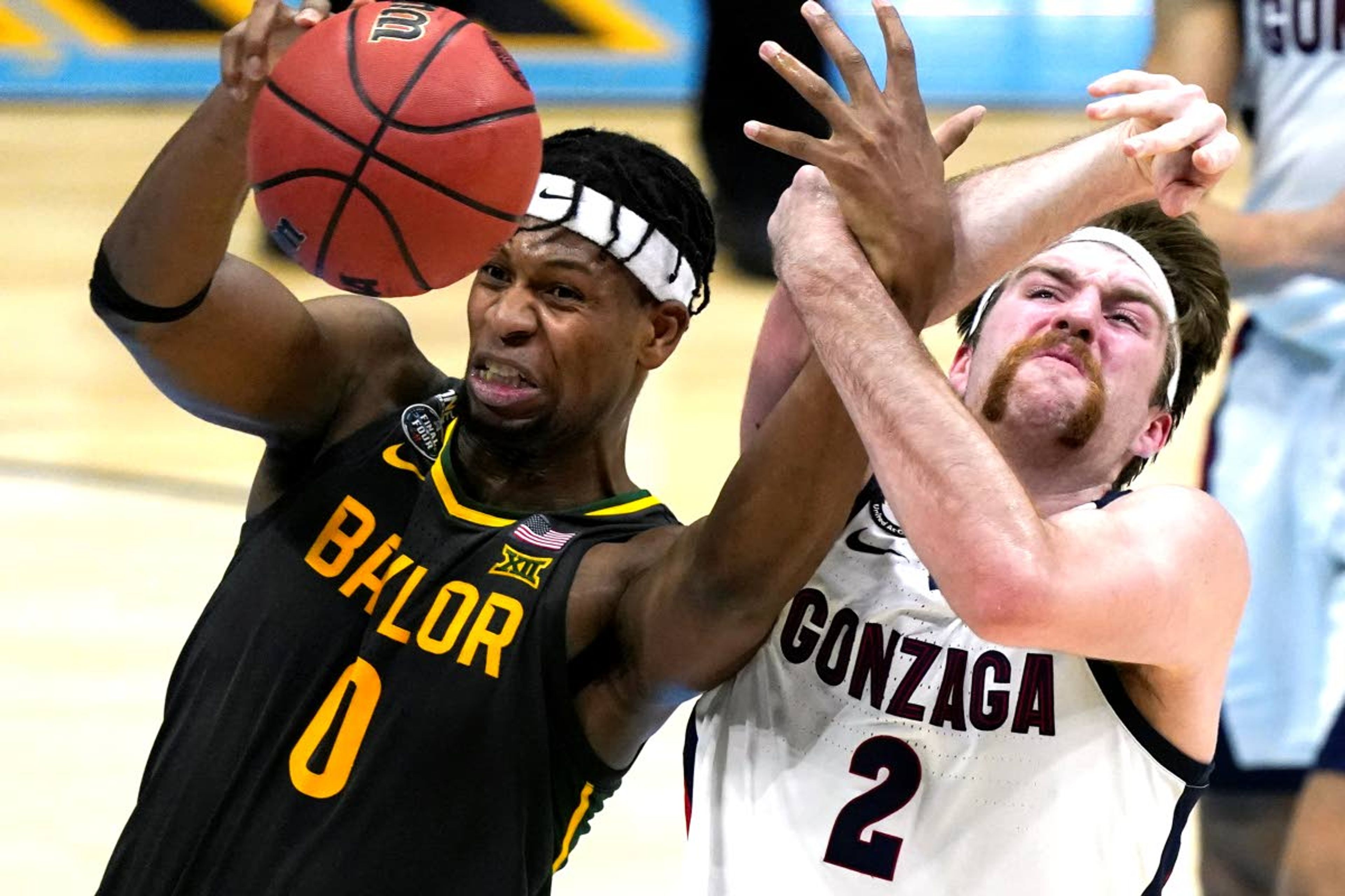 Baylor forward Flo Thamba (0) fights for a rebound with Gonzaga forward Drew Timme (2) during the first half of the championship game in the men's Final Four NCAA college basketball tournament, Monday, April 5, 2021, at Lucas Oil Stadium in Indianapolis. (AP Photo/Michael Conroy)