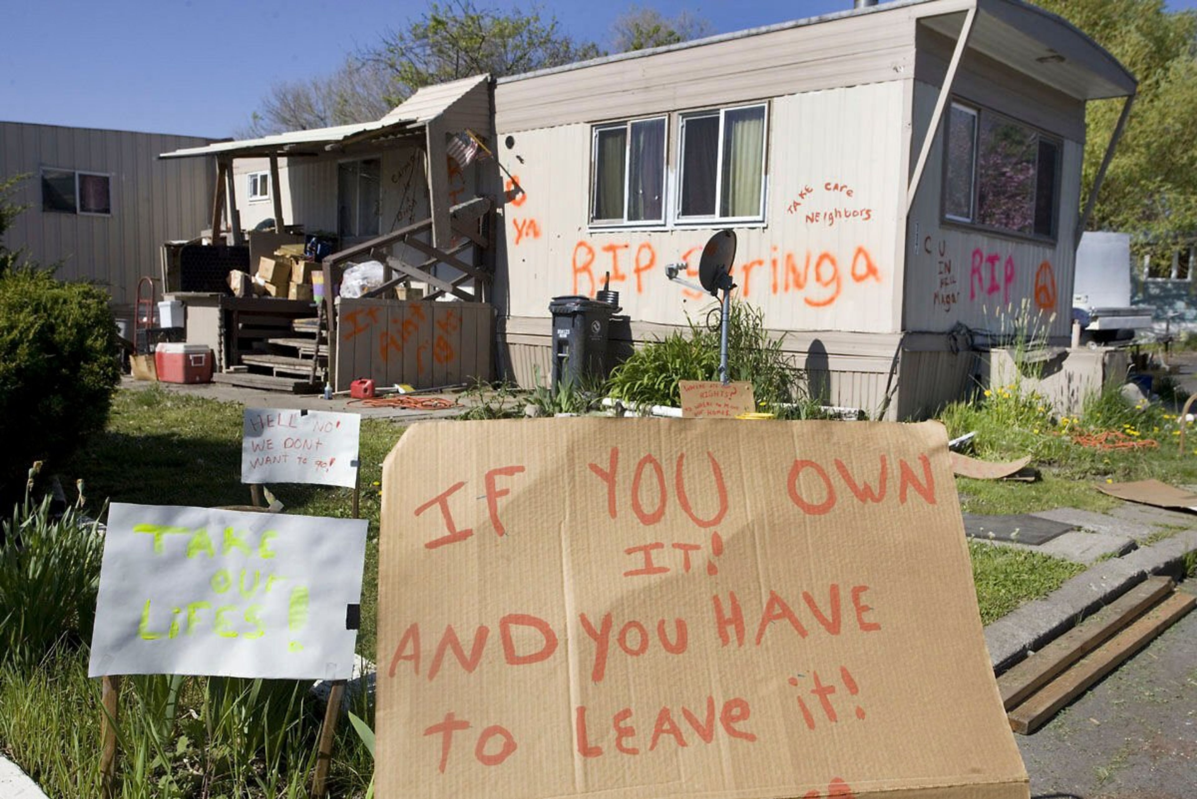 Signs outside a mobile home talk about the pending closure of Syringa Mobile Home Park on Tuesday east of Moscow in 2018.