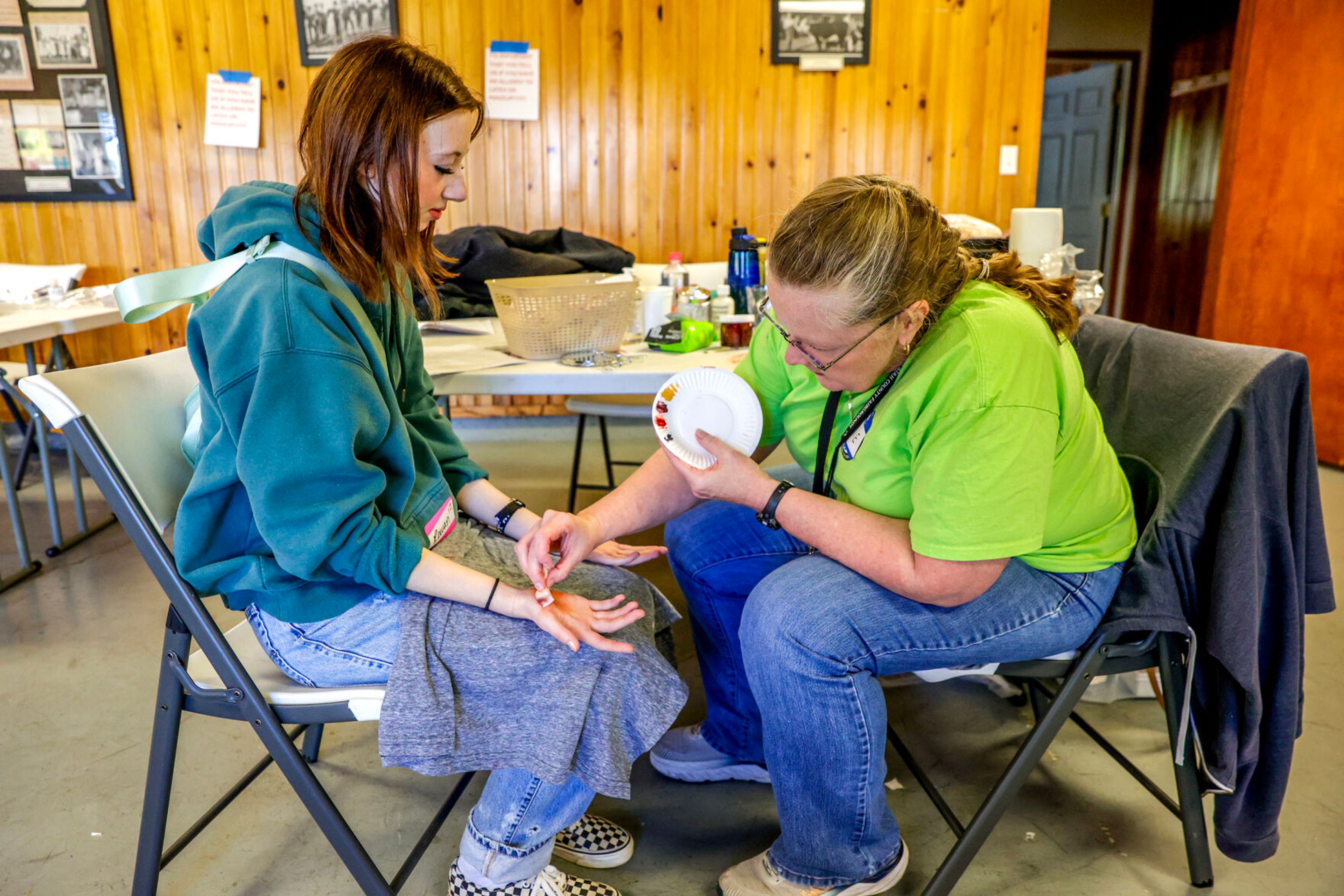 Latah Community Emergency Response Team Program Manager Vickie Lawrence applies a wound to Rowan Manwaring before a disaster simulation of a windstorm Saturday at the Latah County Fairgrounds.