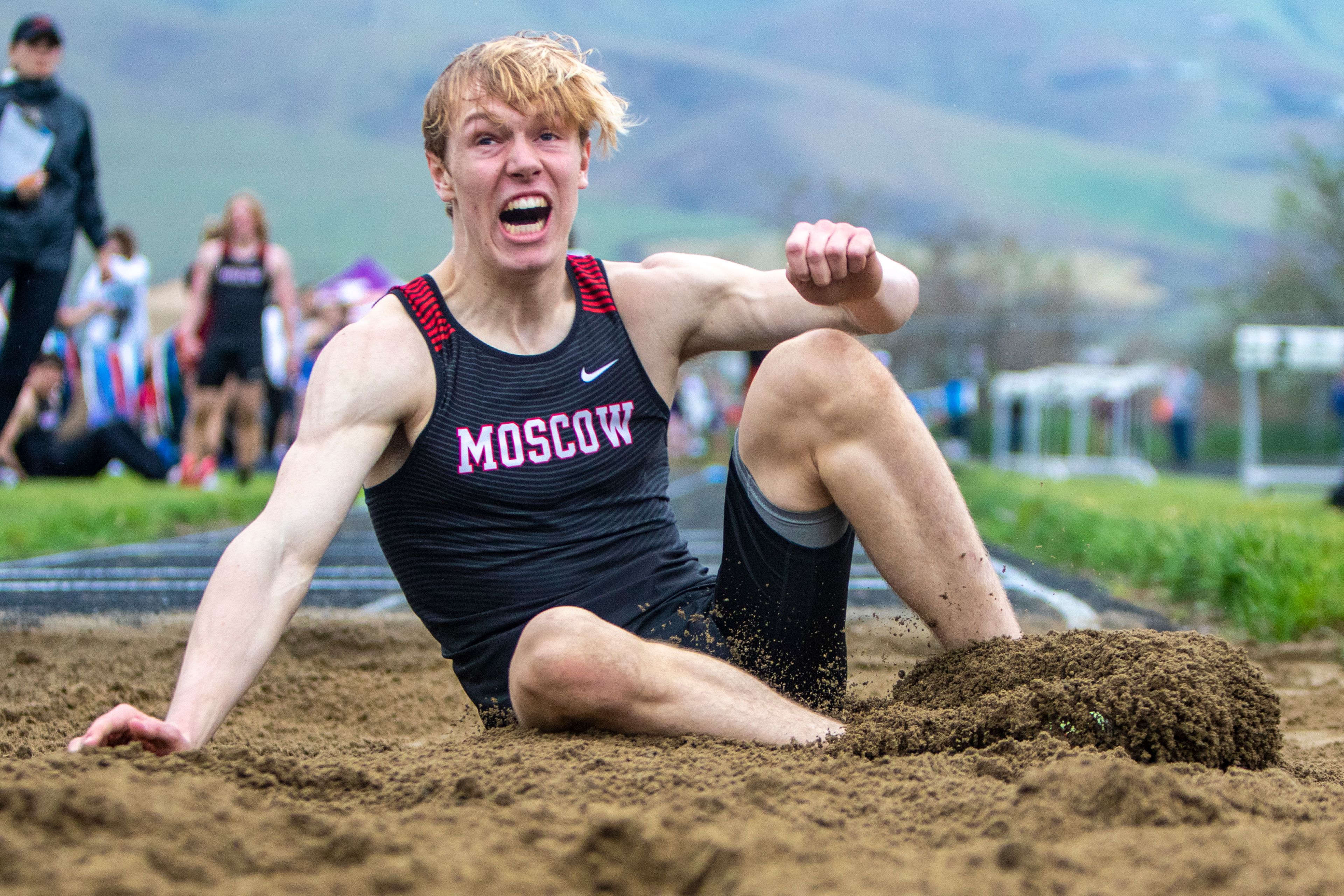 Moscow High junior Caleb Skinner lands with force competing in the triple jump event Thursday during the District 1 Meet of Champions at Vollmer Park in Lewiston.