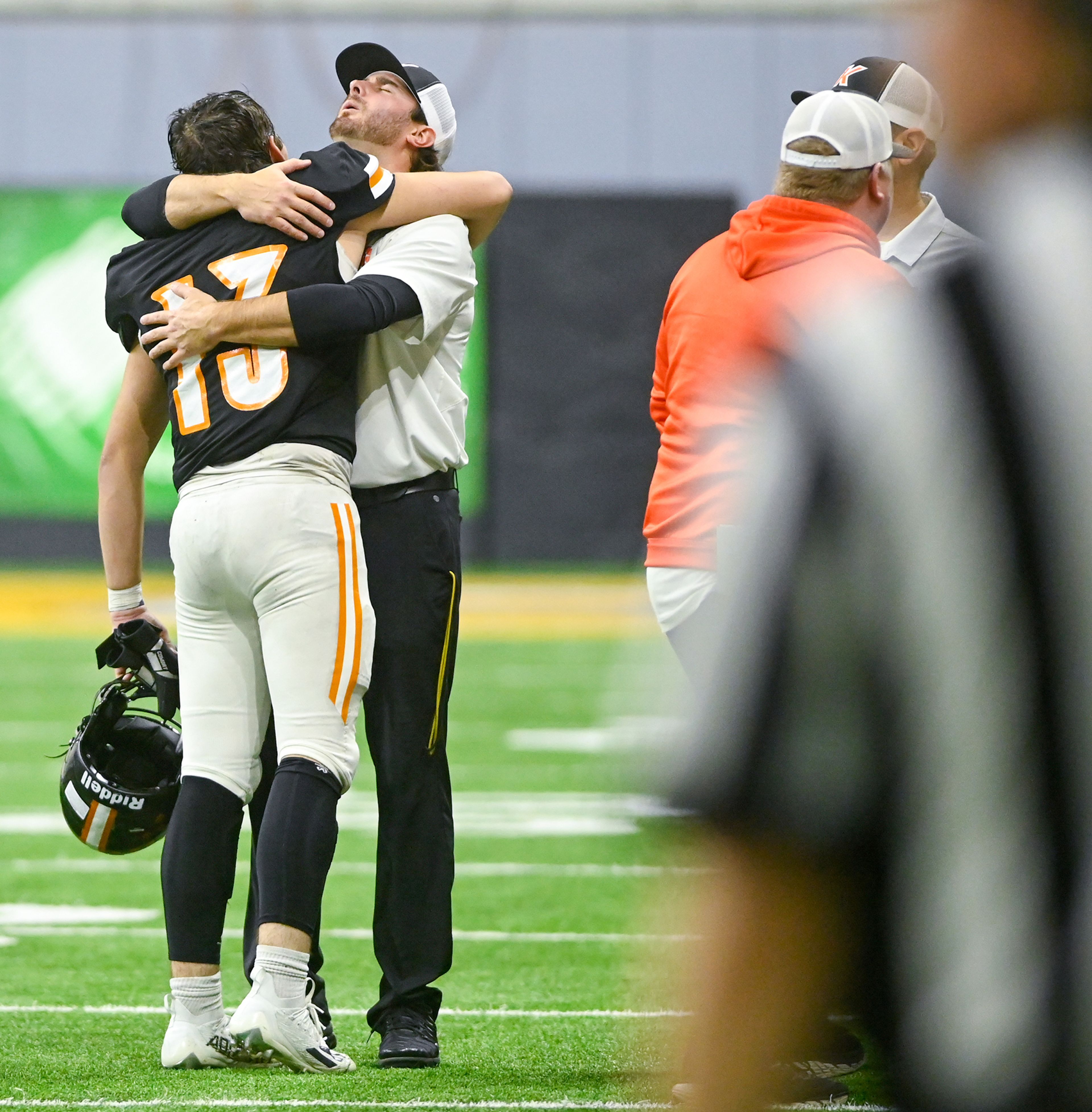 Kendrick’s Caleb O’Bryant and head coach Zane Hobart hug after a final substitution of players off the field Friday during the Idaho 2A football state championship game against Butte County at the P1FCU Kibbie Dome in Moscow.