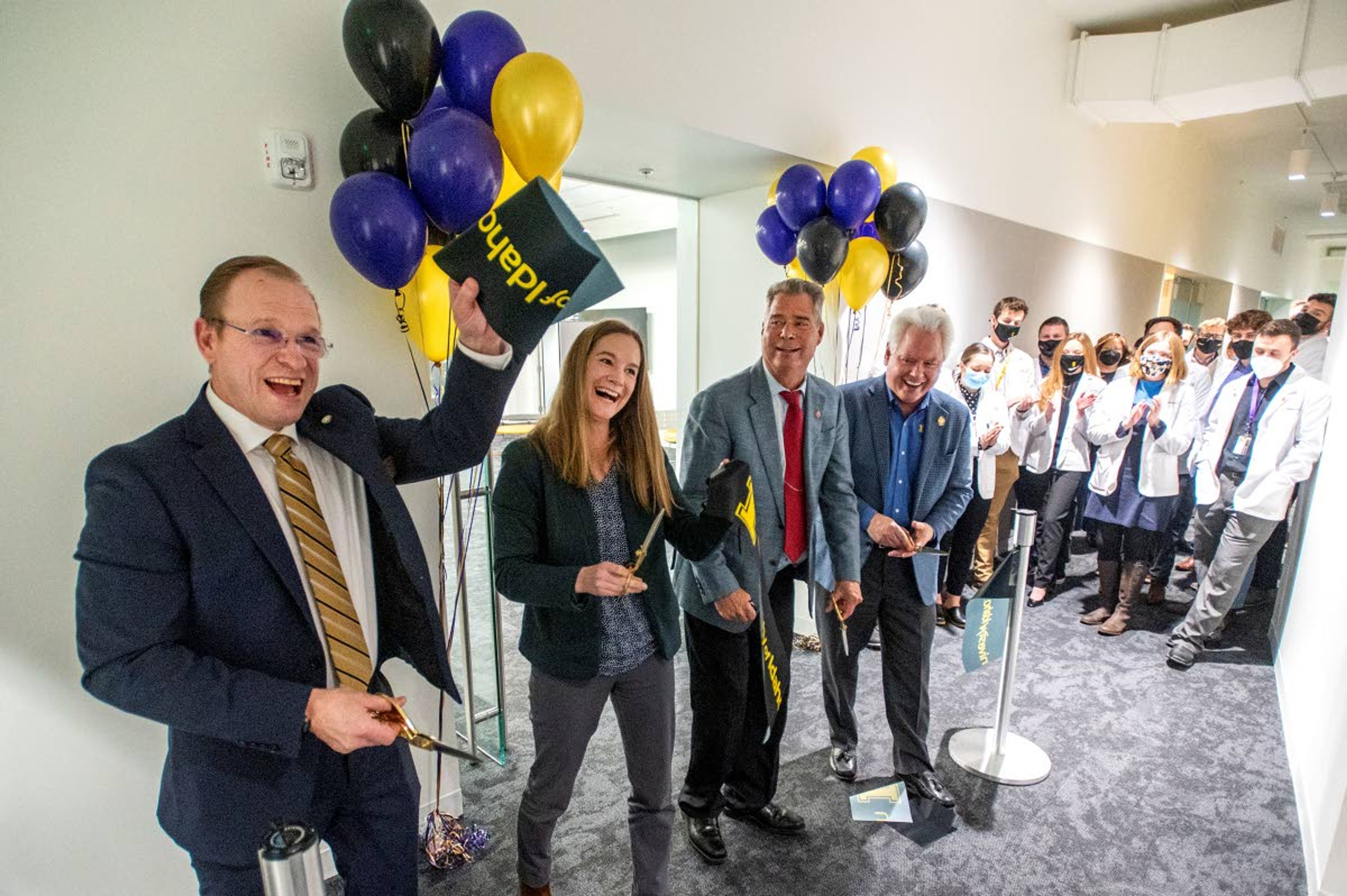 Photos by Zach Wilkinson/Daily NewsDirector Jeff Seegmiller, of WWAMI Medical Education Program, from left, Norco CEO Nicole Kissler, Norco Chairman of the Board Jim Kissler, and University of Idaho President Scott Green are applauded Monday night by medical students after cutting the ribbon to celebrate the new Norco classroom at the WWAMI Medical Education Building in Moscow.