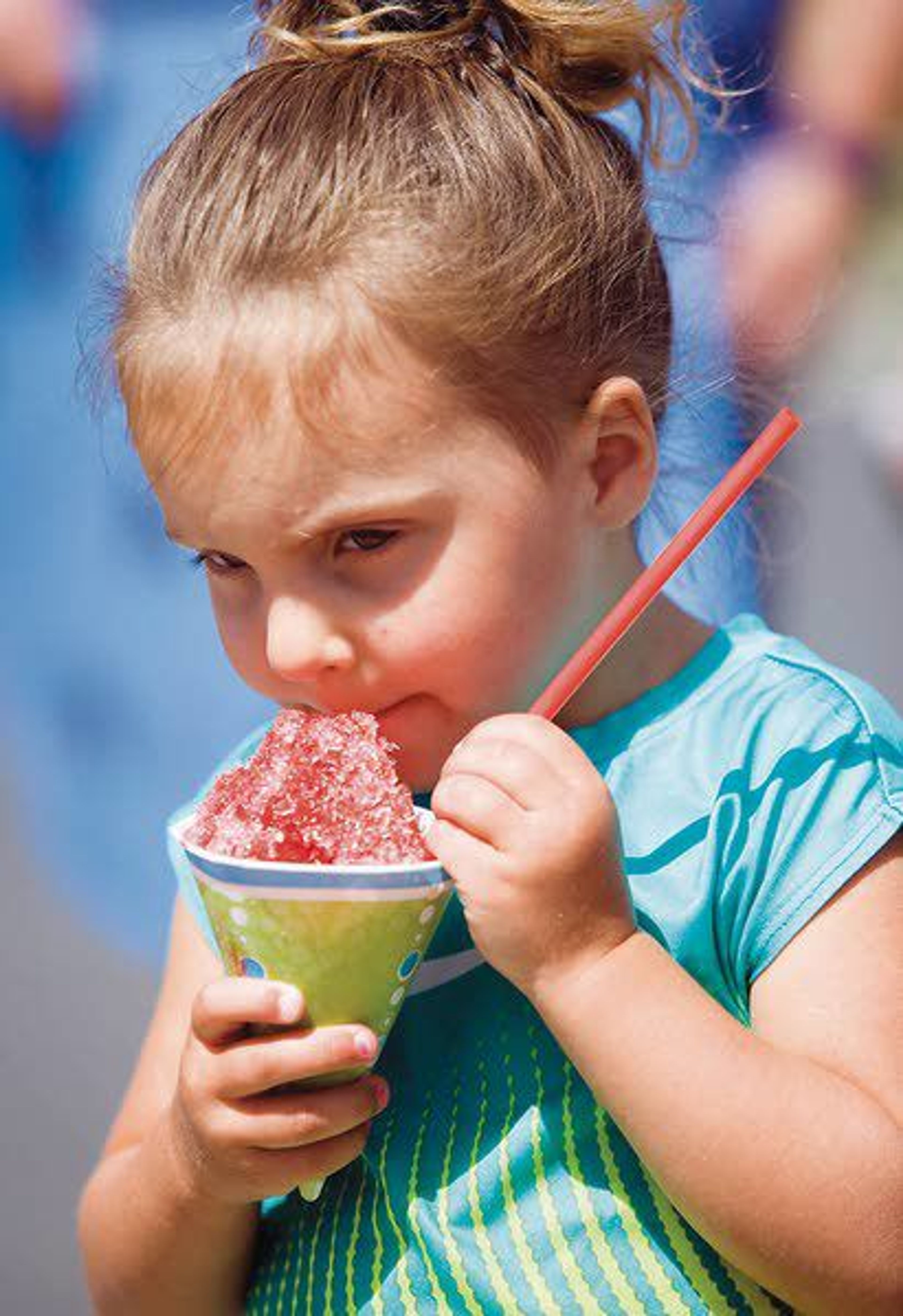 Bella Brown, 3, eats a sno-cone at a lemonade and snack stand Monday in Pullman. The stand was raising money for the Make-A-Wish Foundation.